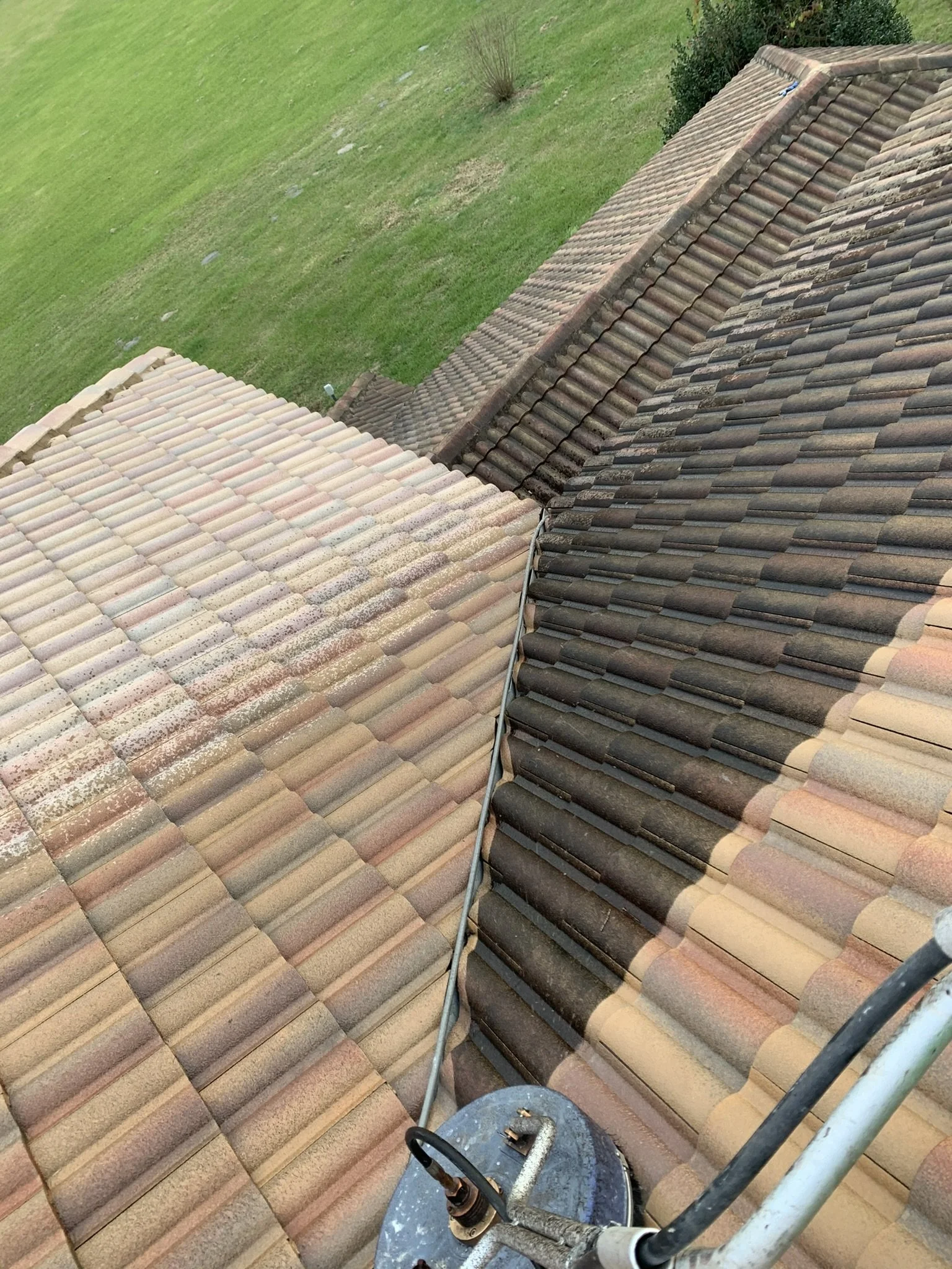 Concrete ceramic tile roof pressure cleaning showing before-and-after  results during property maintenance by HavenForged in Sarasota, Florida.