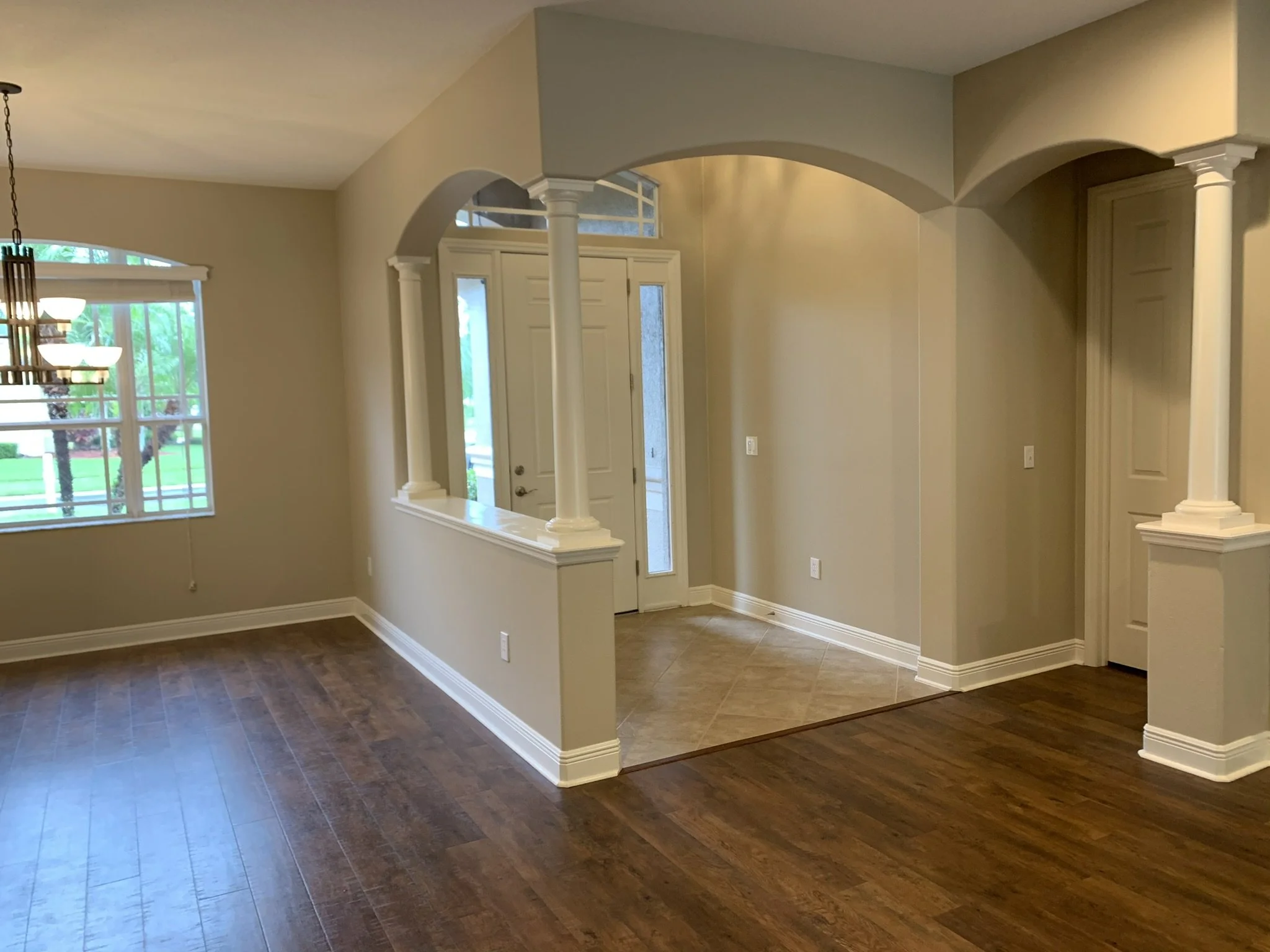 Completed residential interior painting with walls, trim, baseboards, columns and architectural details by HavenForged in Sarasota, FL.