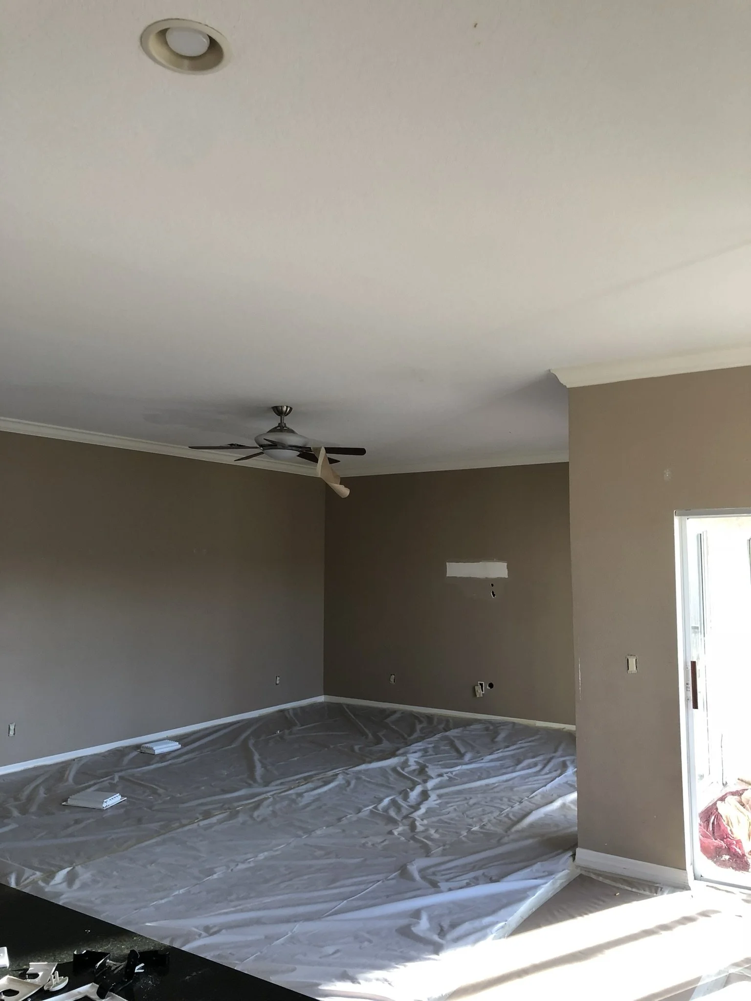 Interior painting preparation with floors protected before repainting walls and trim by HavenForged in Sarasota, Florida.