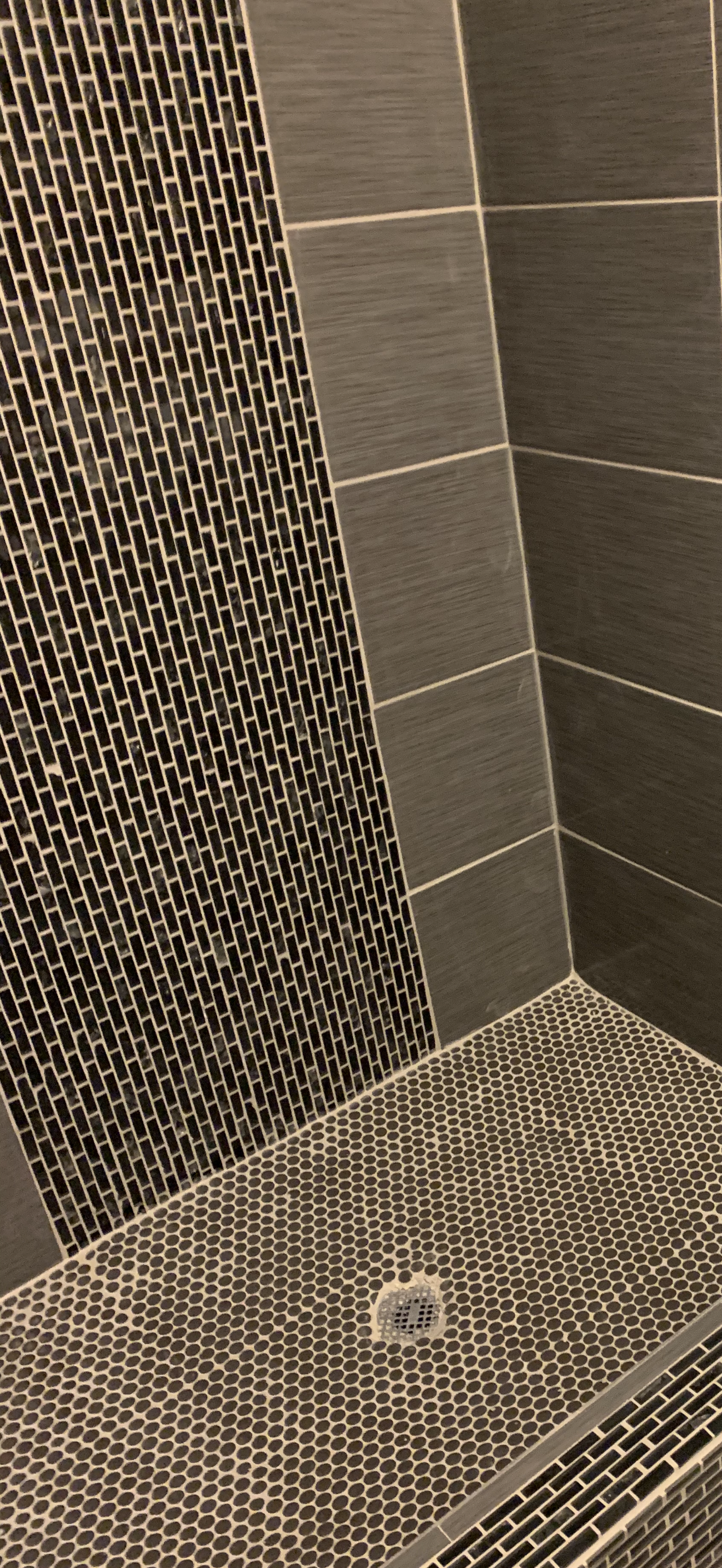 Finished custom tile shower remodel with penny tile floor and tile walls by HavenForged in Sarasota, Florida.
