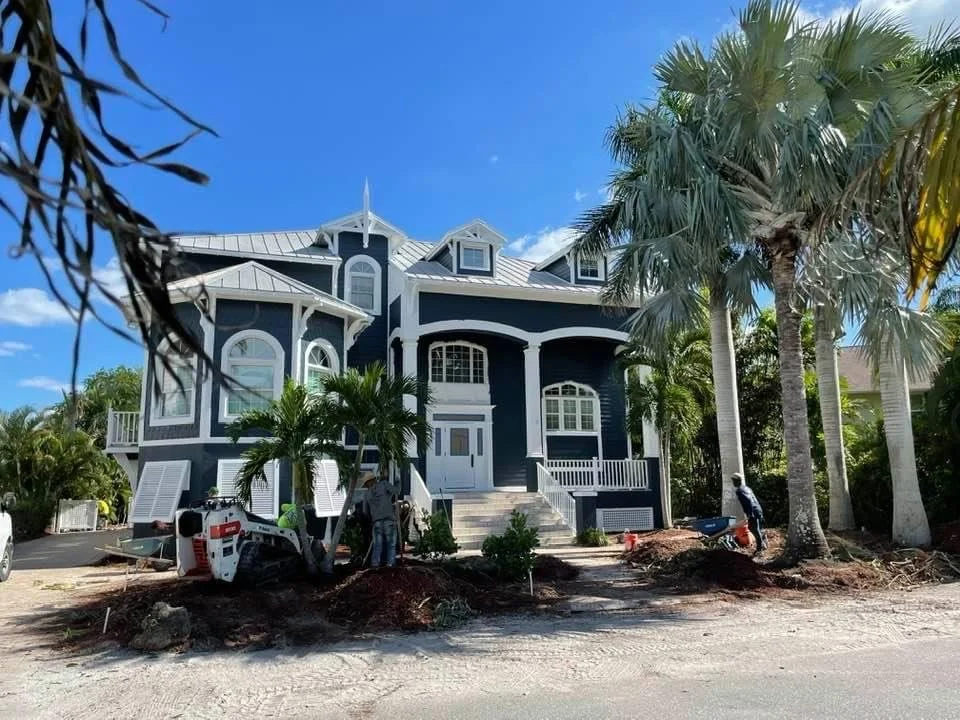 Professional exterior painting of navy-blue coastal home with white trim by HavenForged in Sarasota Florida.