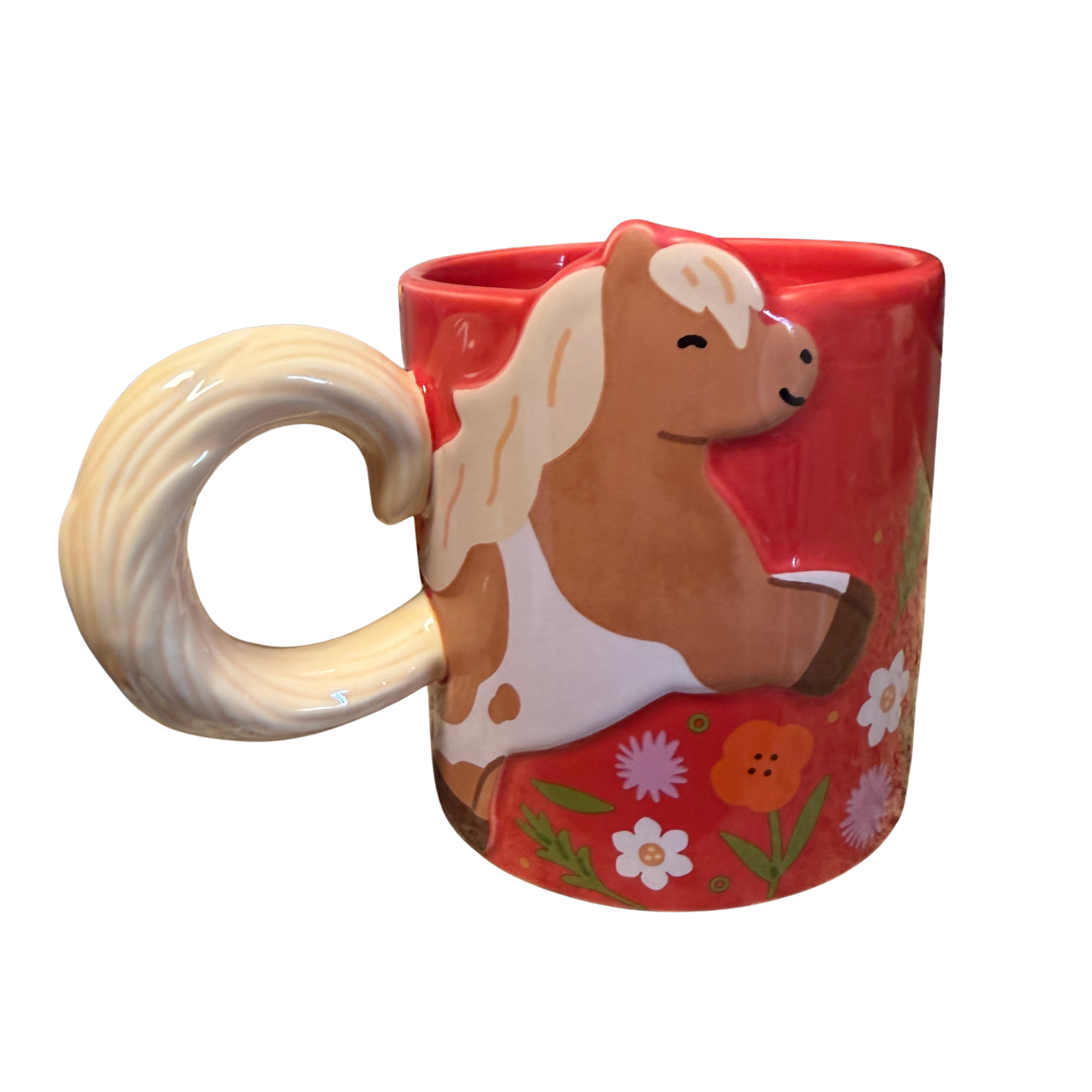 Colorful ceramic mug with a dog face painted on it, filled with a beverage, and a floral-patterned ceramic plate or bowl nearby, against a black background.