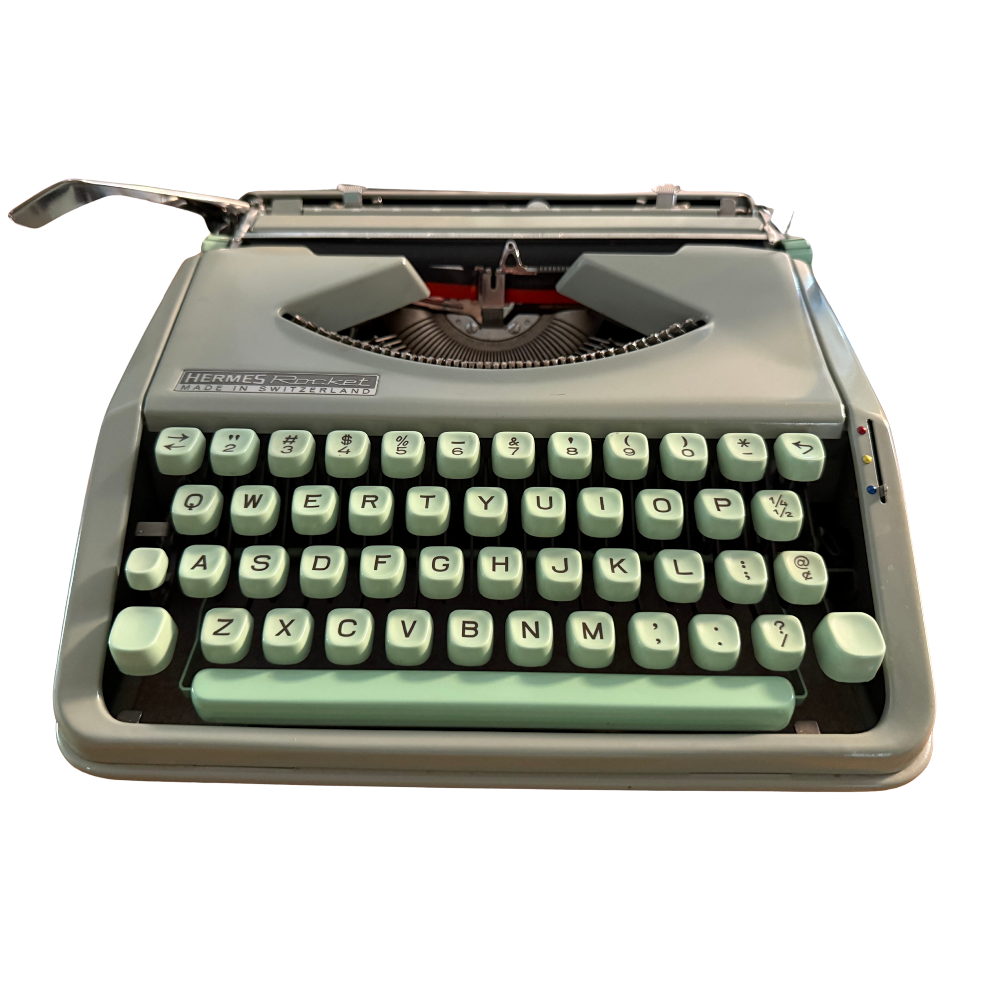 A vintage Hermes Rocket typewriter with green keys and gray body.