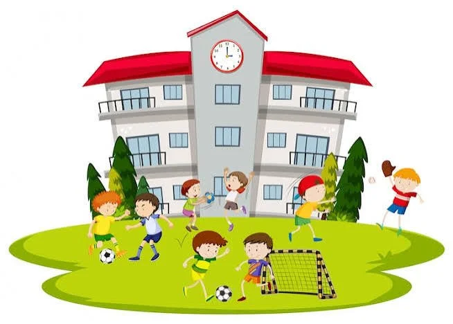 Children playing soccer and doing activities on a grassy area outside a school building with a clock on top, surrounded by trees.