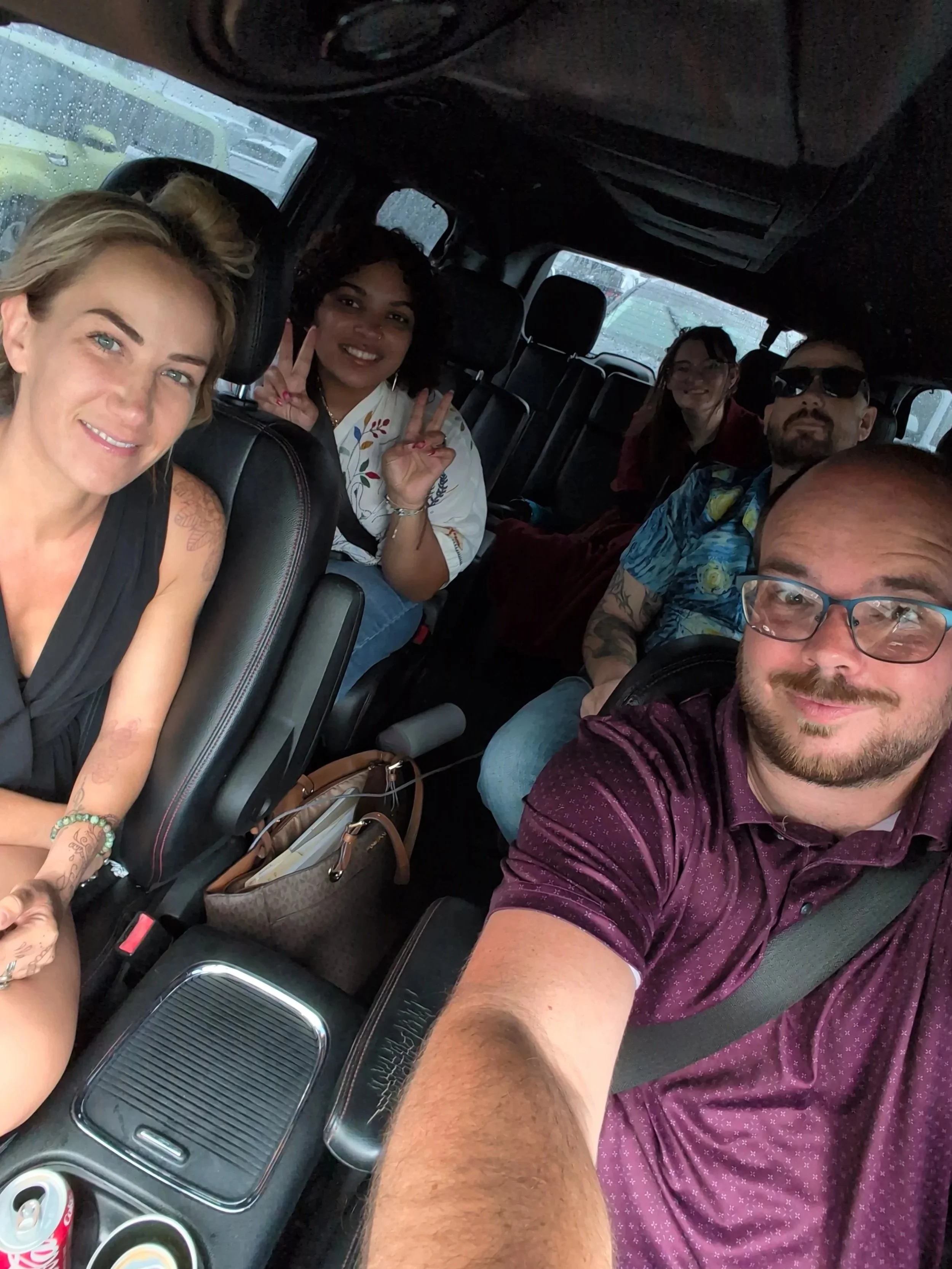 The Breakthroughs LLC team in a van during a roadtrip.