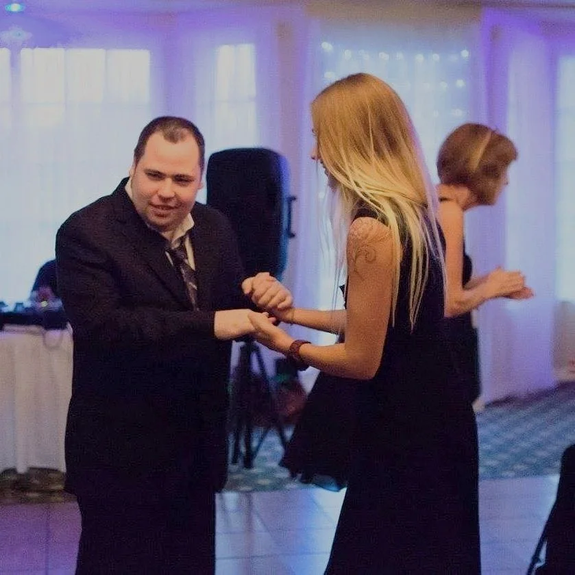 Client dancing in formal wear with a Breakthroughs LLC team member.