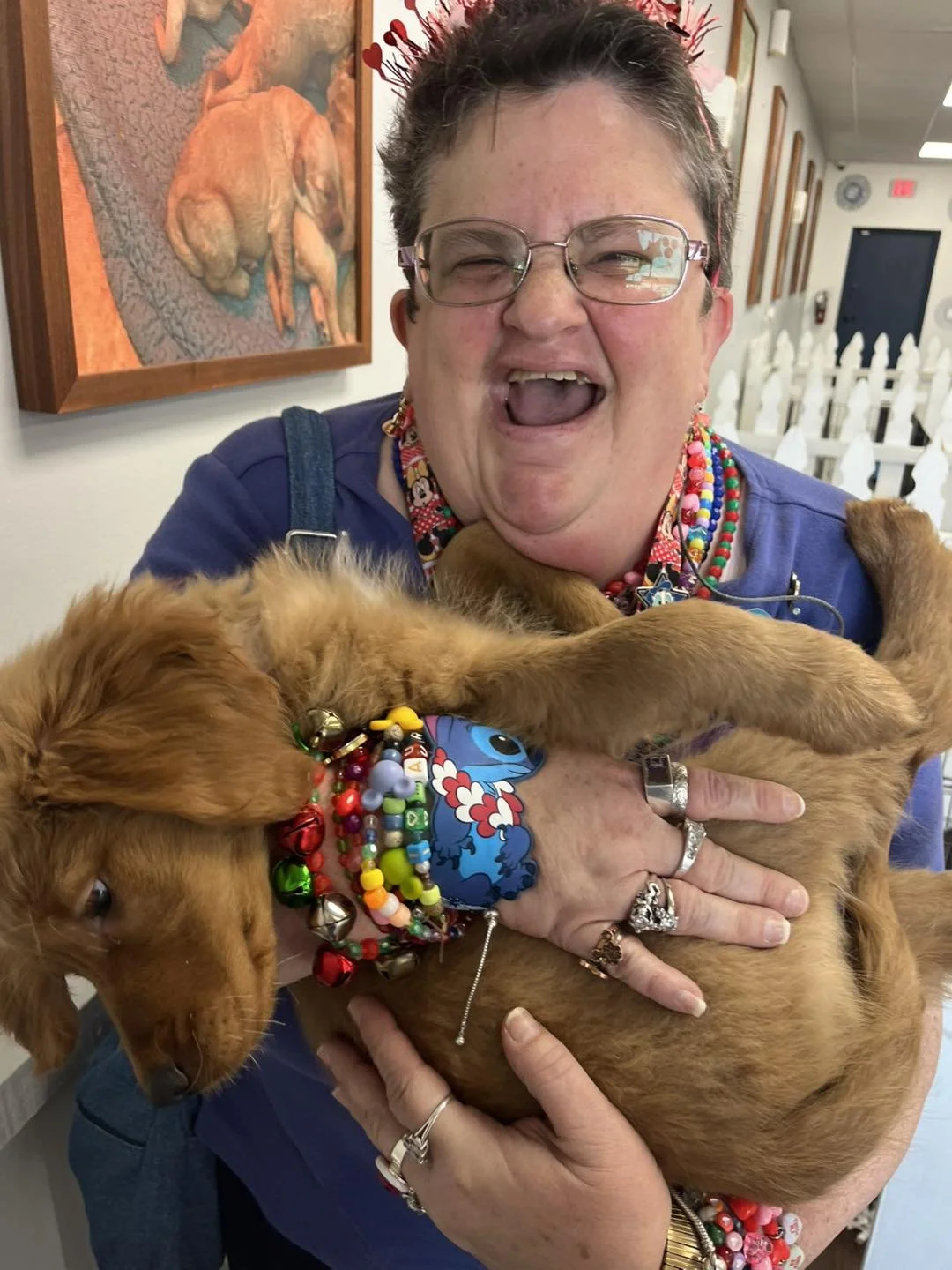 Laughing Breakthroughs LLC client celebrates while holding a dog.