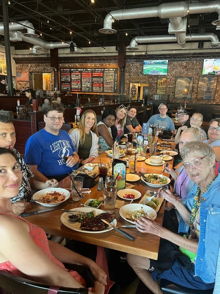 The Breakthroughs LLC team having a wonderful dinner with smiling clients.