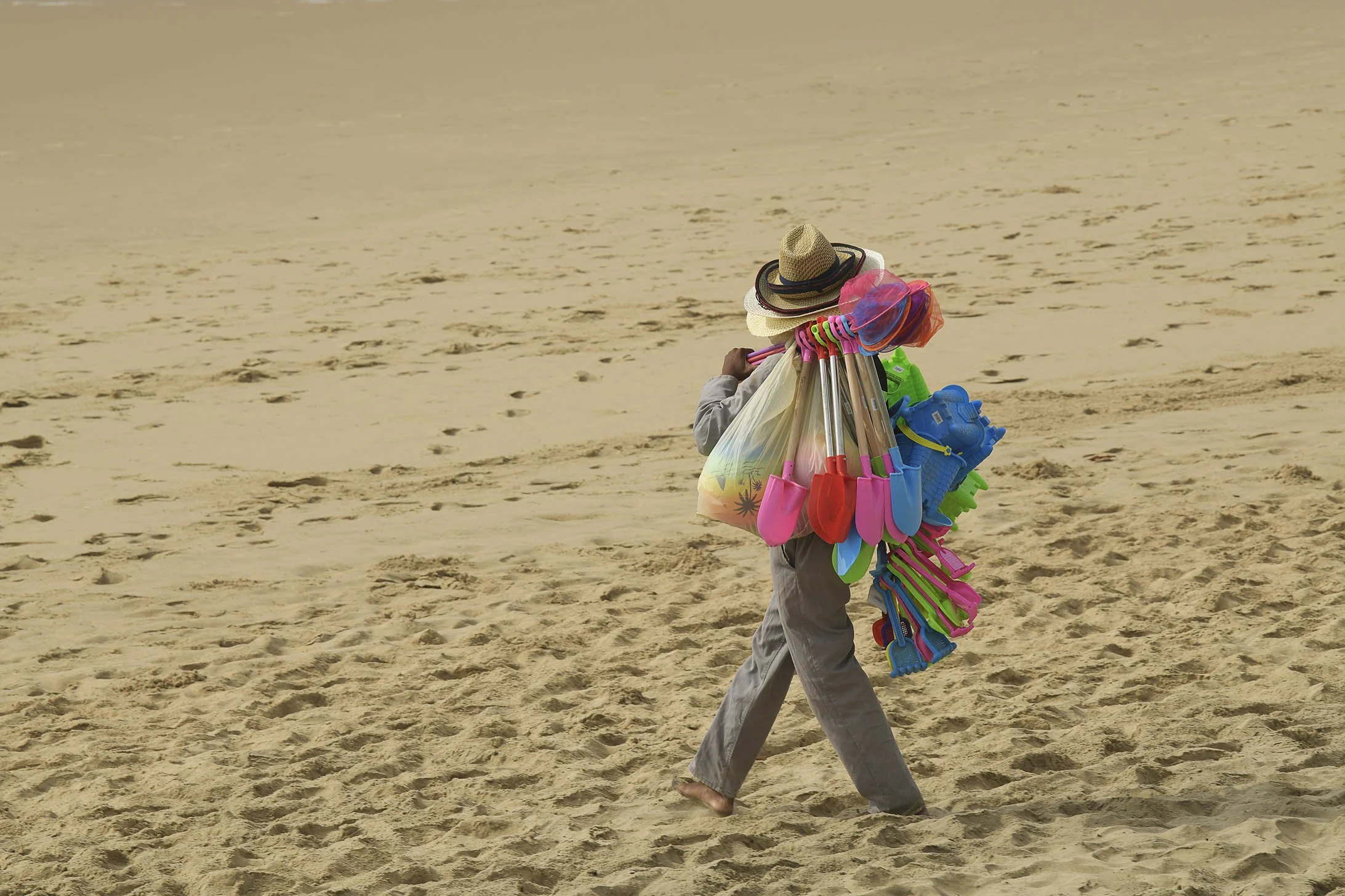 Toy seller working the beach during vacation season