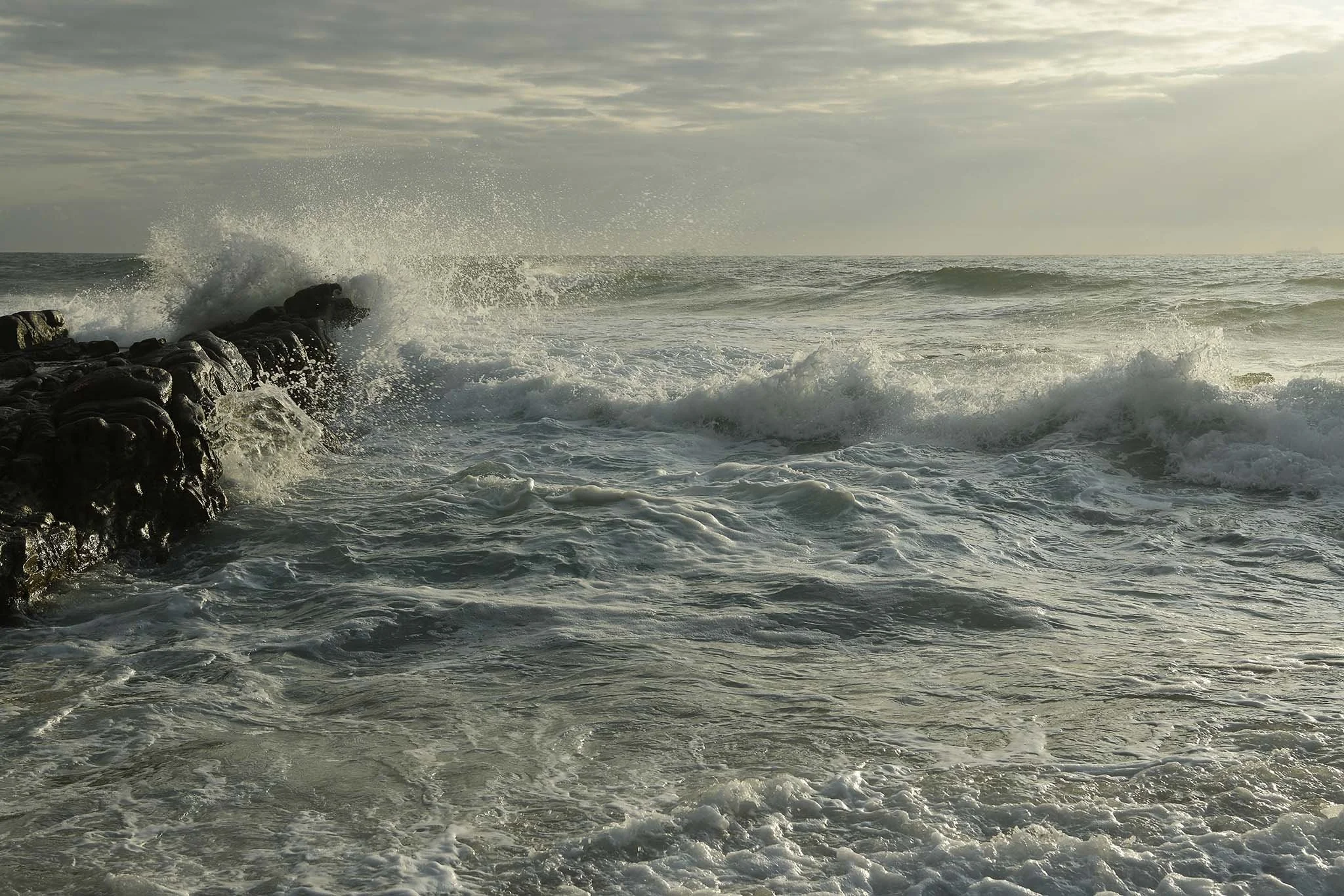 Art photography or scientific illustration showing a force of nature, wave splashing against rock