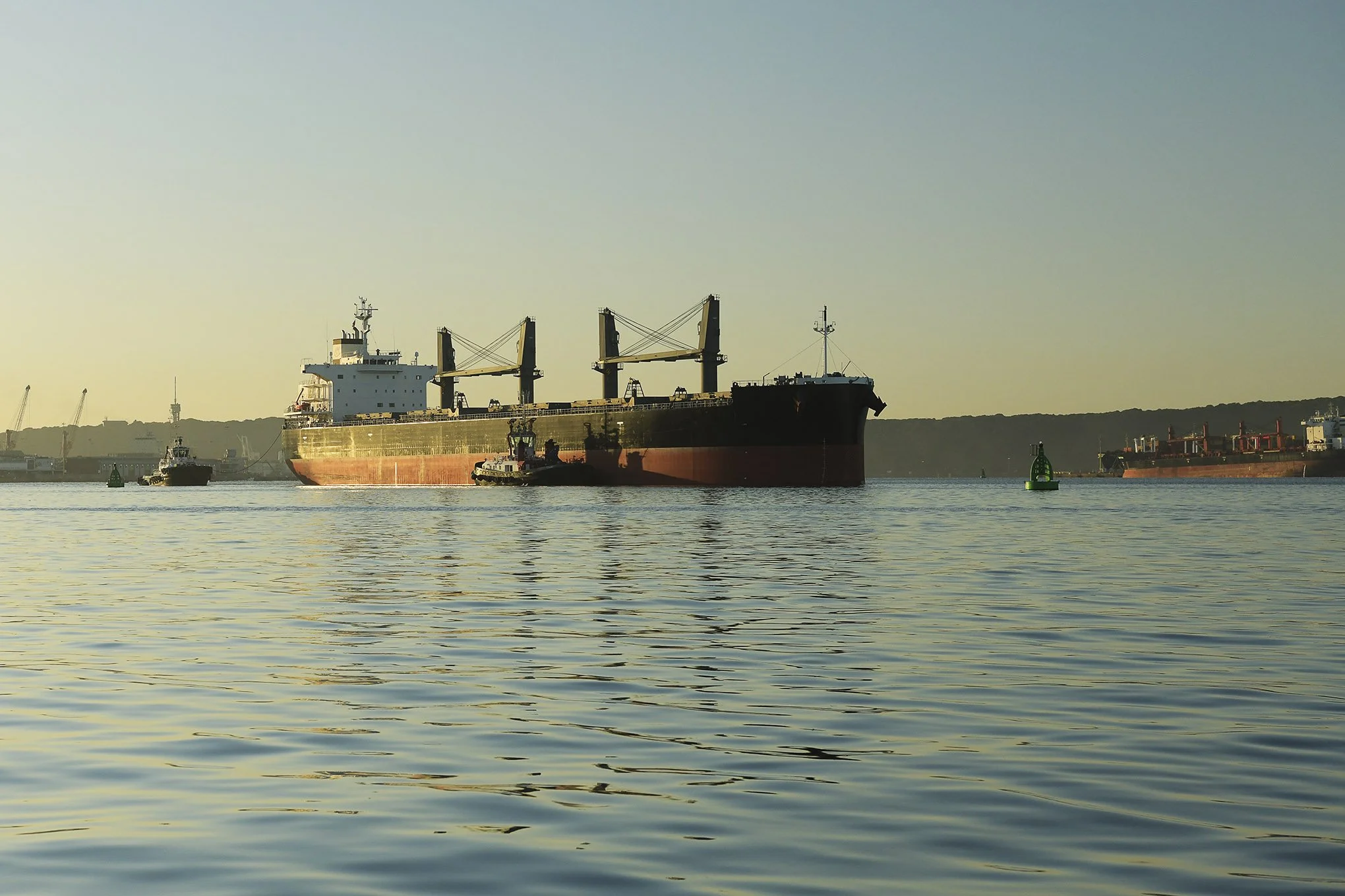 Illustration of tugboats assisting cargo ship in port of Durban, with copy space 