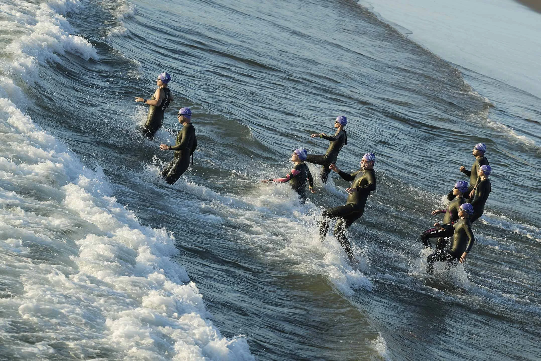 Competitors running into water at start of Swimming leg in the Iron Man Triathlon