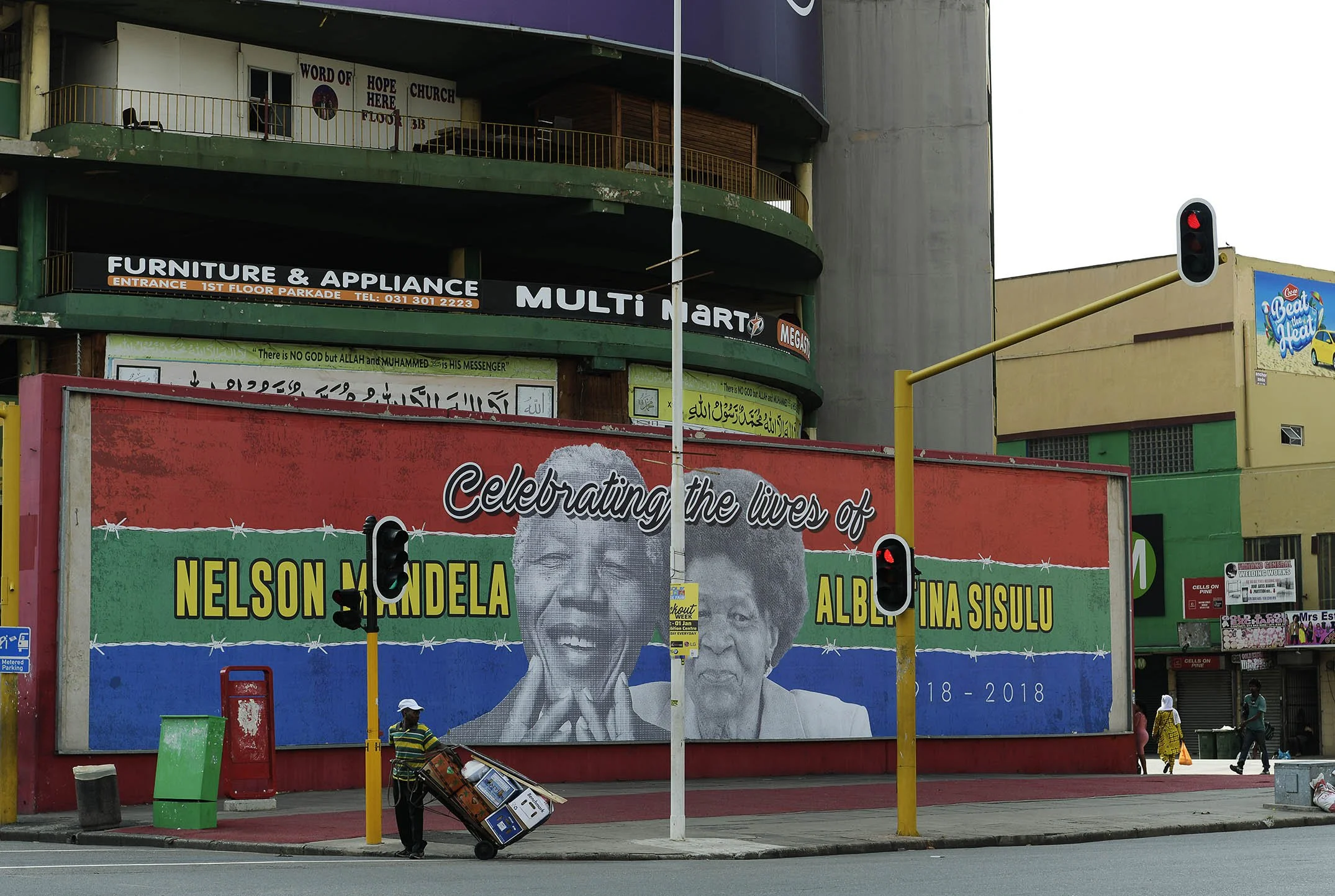 Stalwarts of a political party on wall display, street corner in downtown Durban