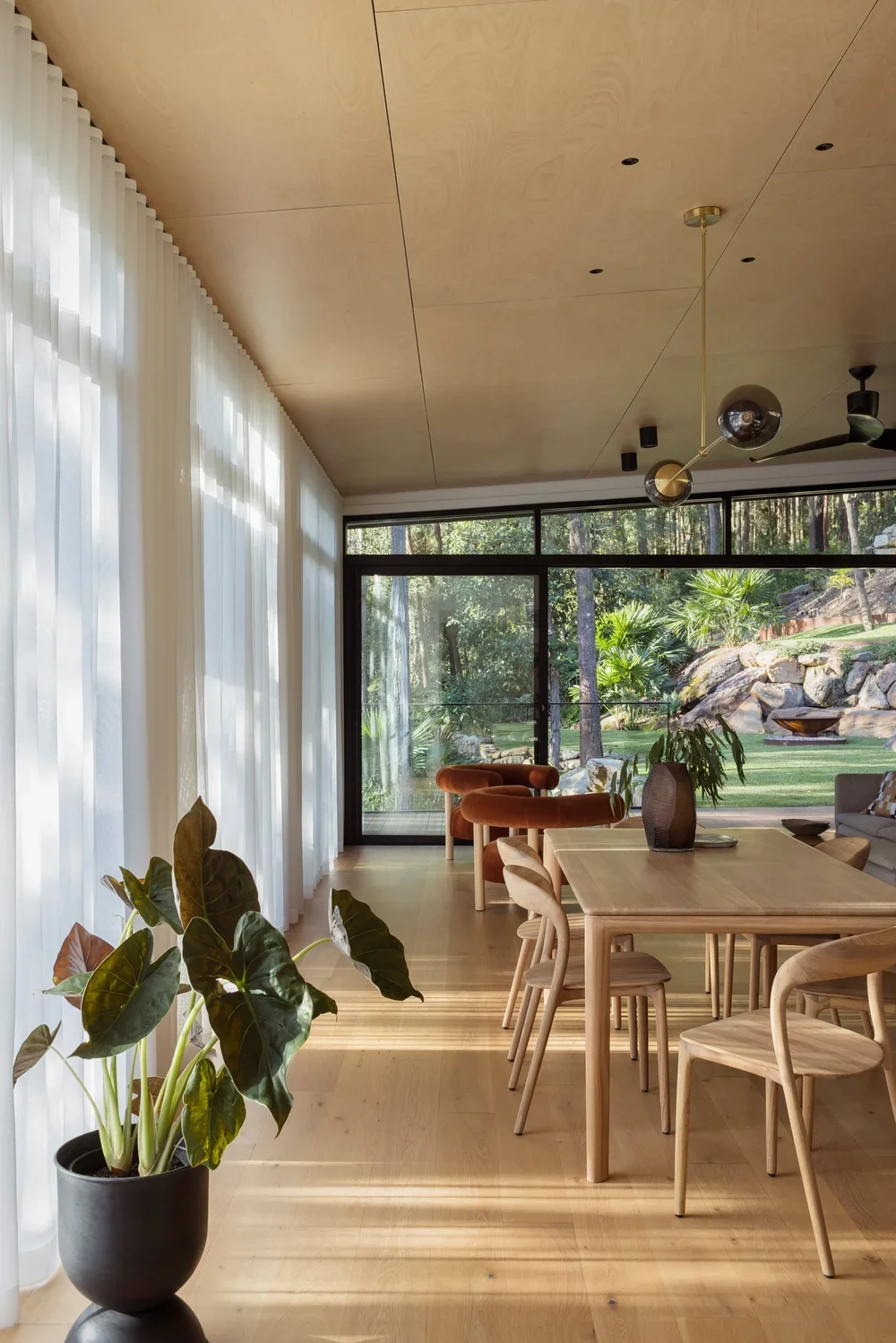 Terraced lawn extending from the home's light-filled living spaces.webp