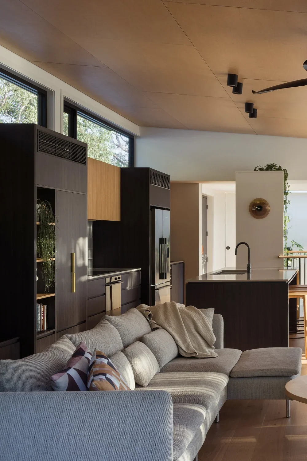 Contemporary kitchen combining timber joinery with understated finishes.webp