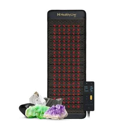 Heated infrared chair with rocks and crystals in front, produced by HealthyLine.