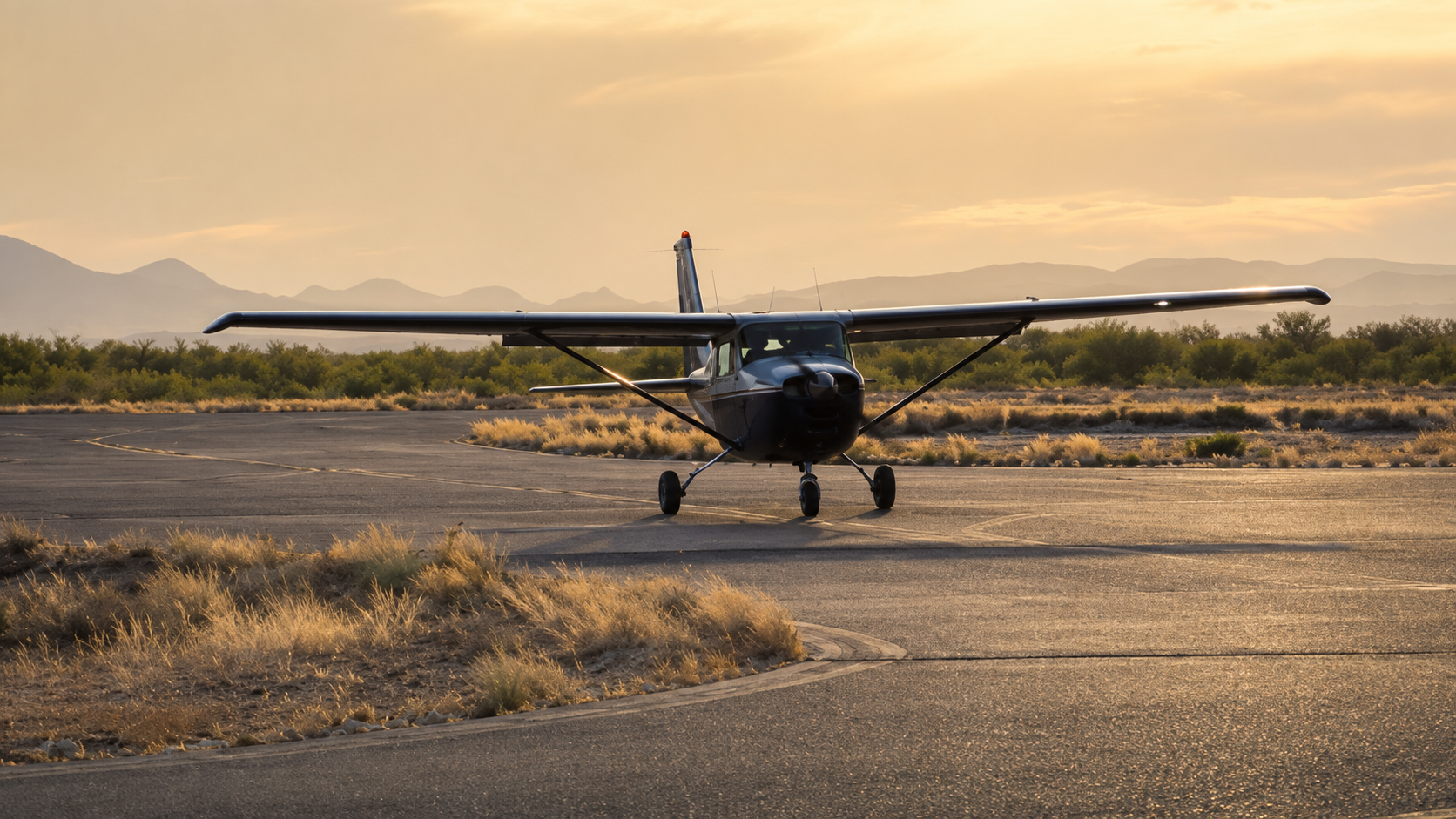 Cessna 172 N3988L on the ramp at Ryan Airfield, Tucson, Arizona at sunset with mountains in background