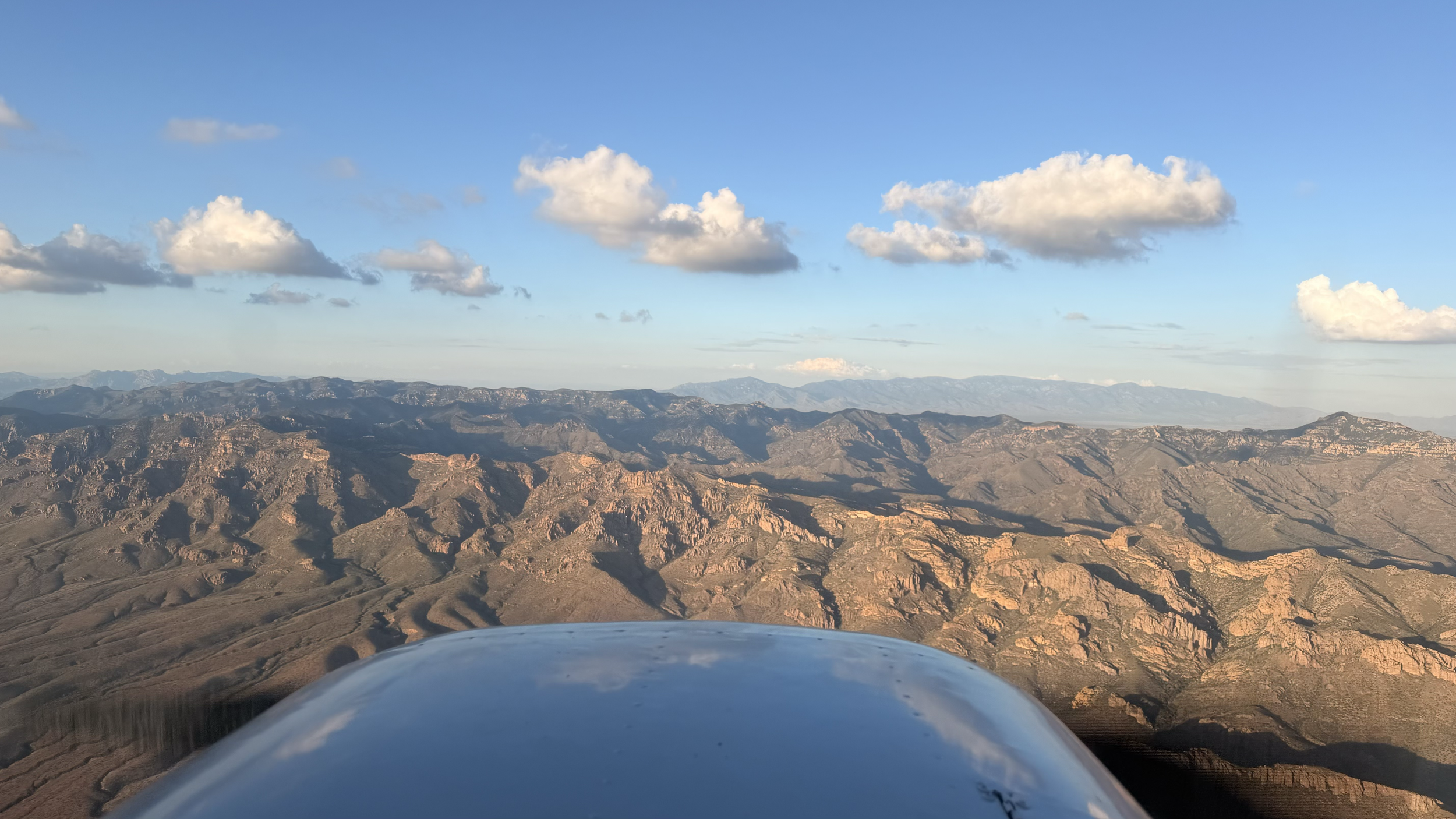 Mountain ridges ahead of a Wind Walker Cessna in flight