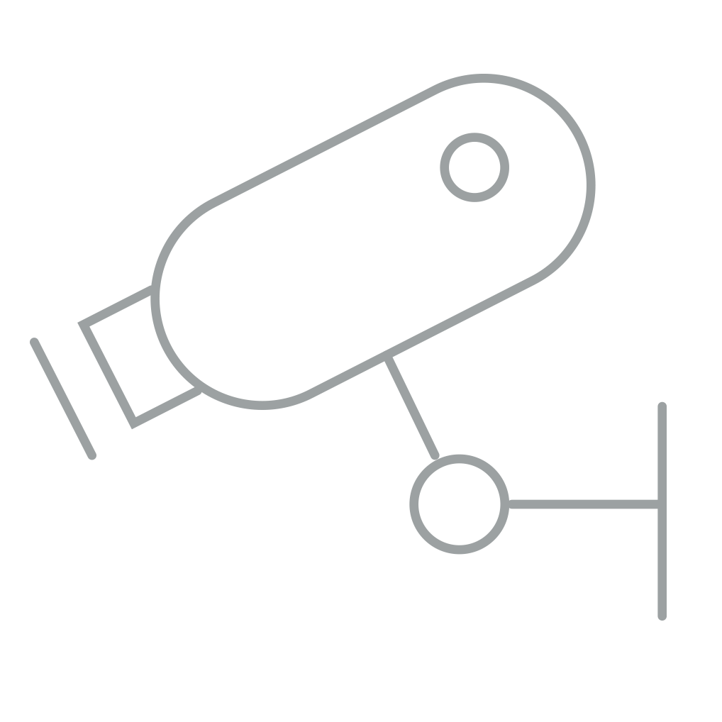 Line drawing of a security camera mounted on a wall.