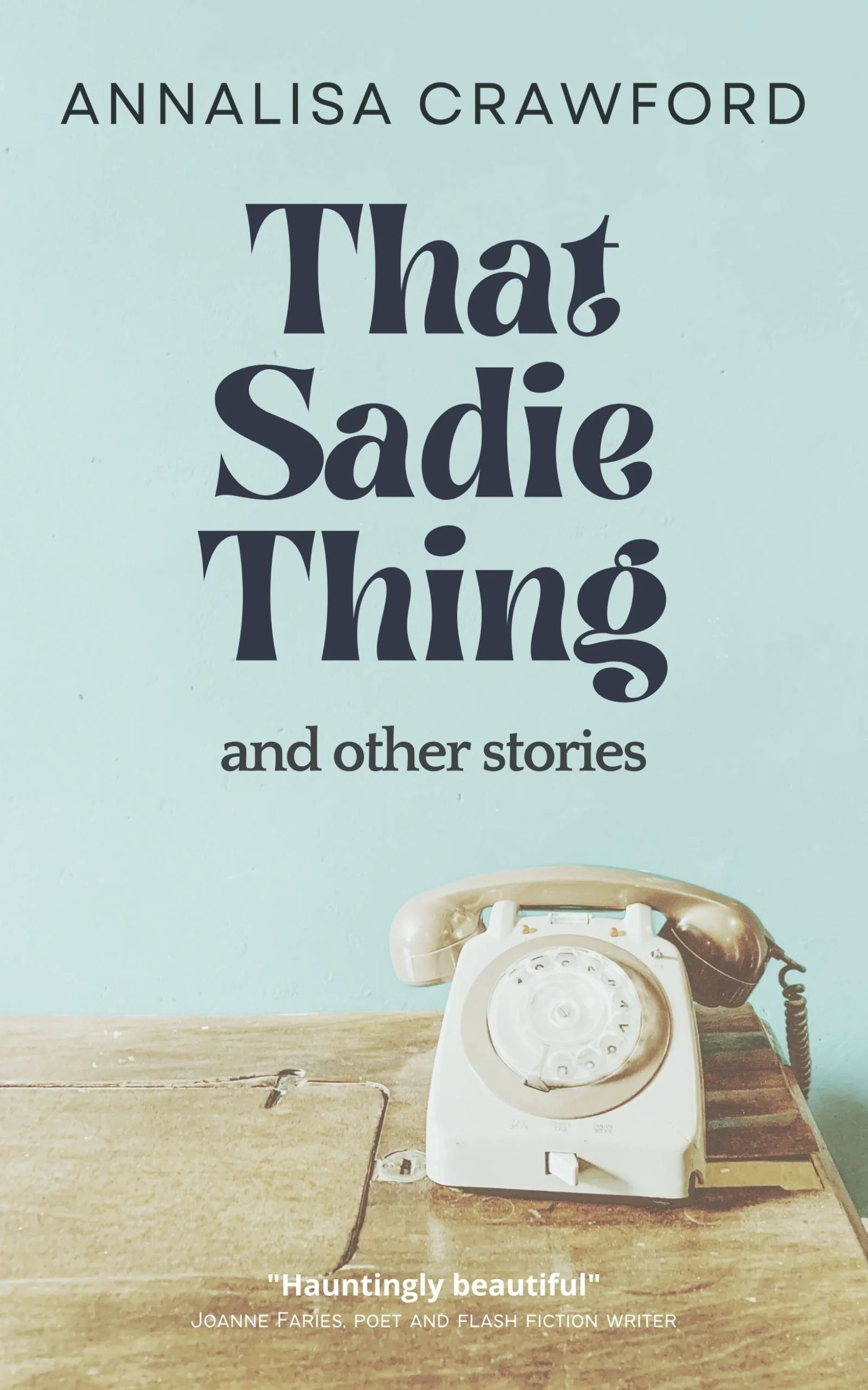 Book cover of 'That Sadie Thing and other stories' by Annalisa Crawford; includes an old rotary telephone on a wooden surface in front of a light blue wall.