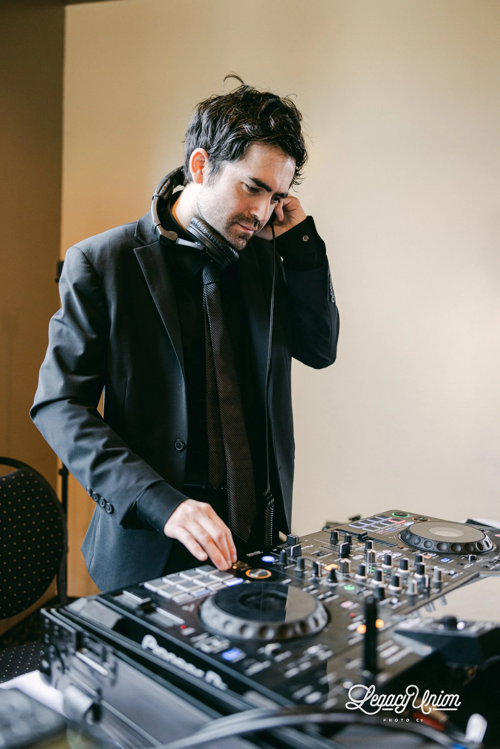 Wedding DJ Cliff Mertens cueing the next track at an event.