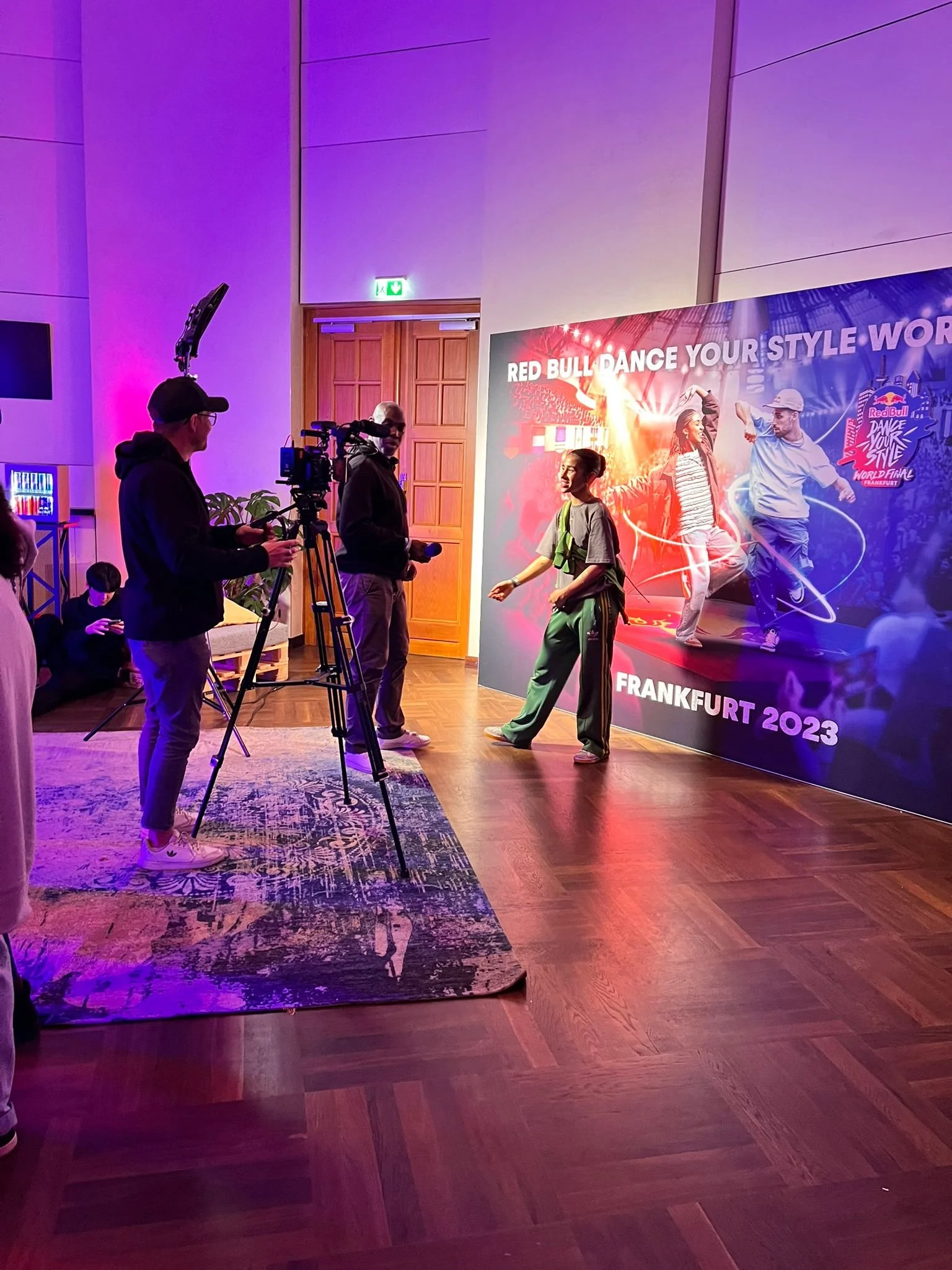 Joseph Allen filming a contestant at a red bull dance event.