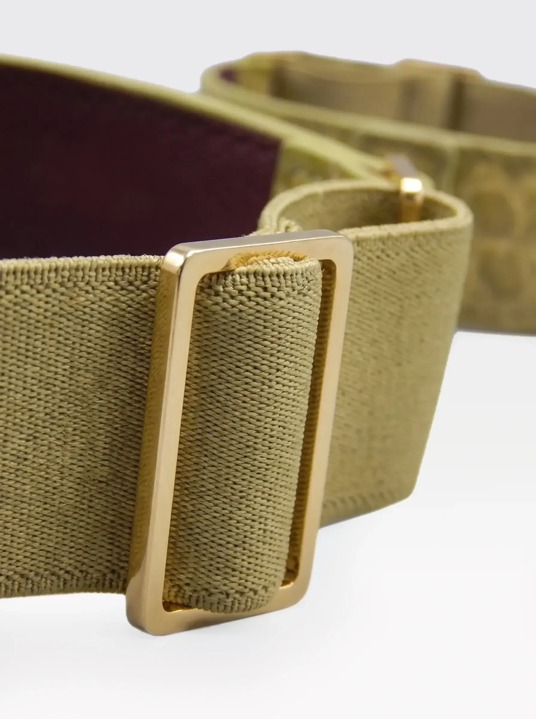 Close-up of the 24K gold-plated brass slider on the pistachio elastic band of a Sainte Sve Arm Bracelets Croc