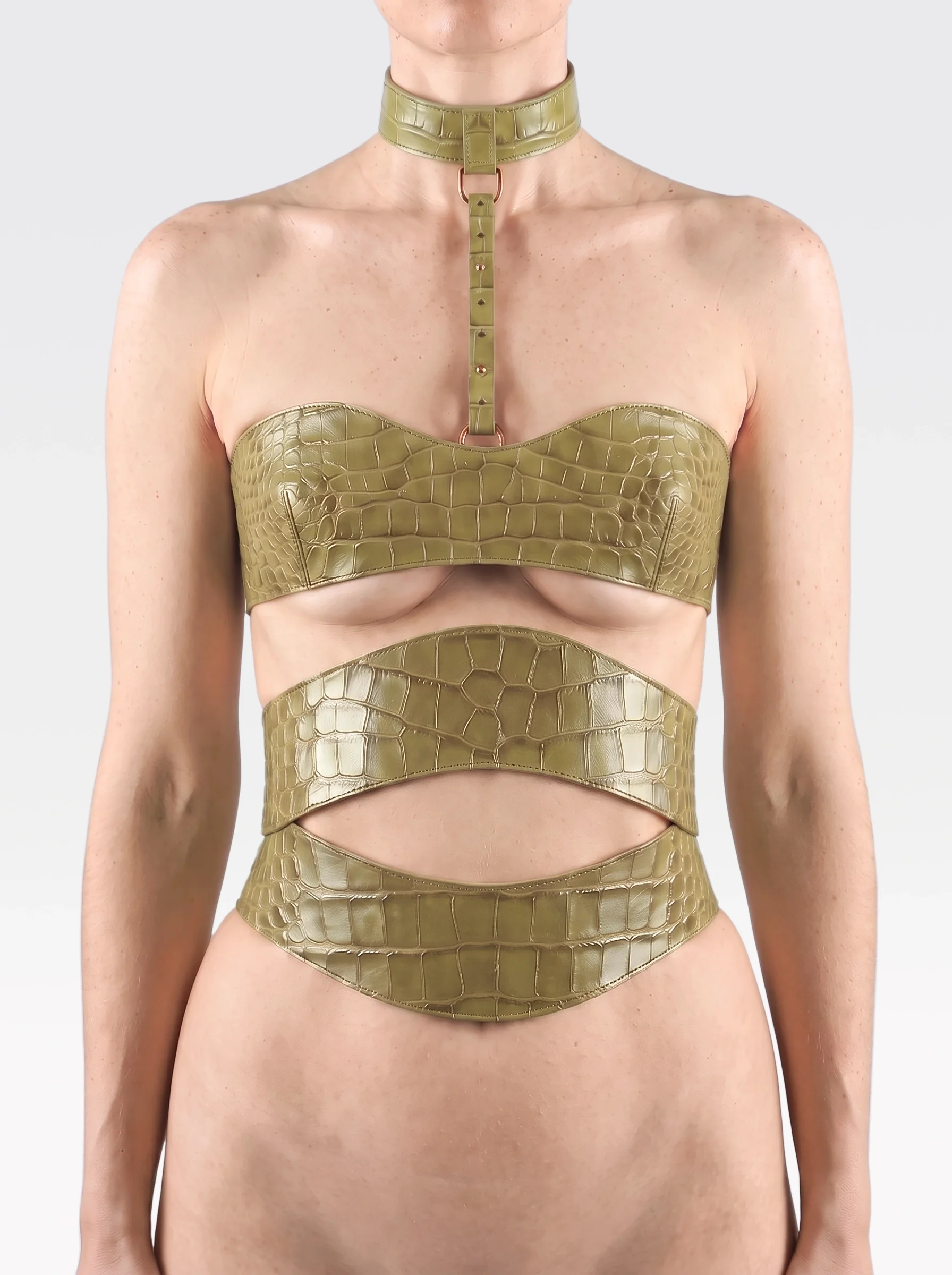 Sainte Sve V.N.V Croc in pistachio crocodile-embossed lambskin with pistachio elastic bands and zip, worn from neck to waist, front view, editorial image
