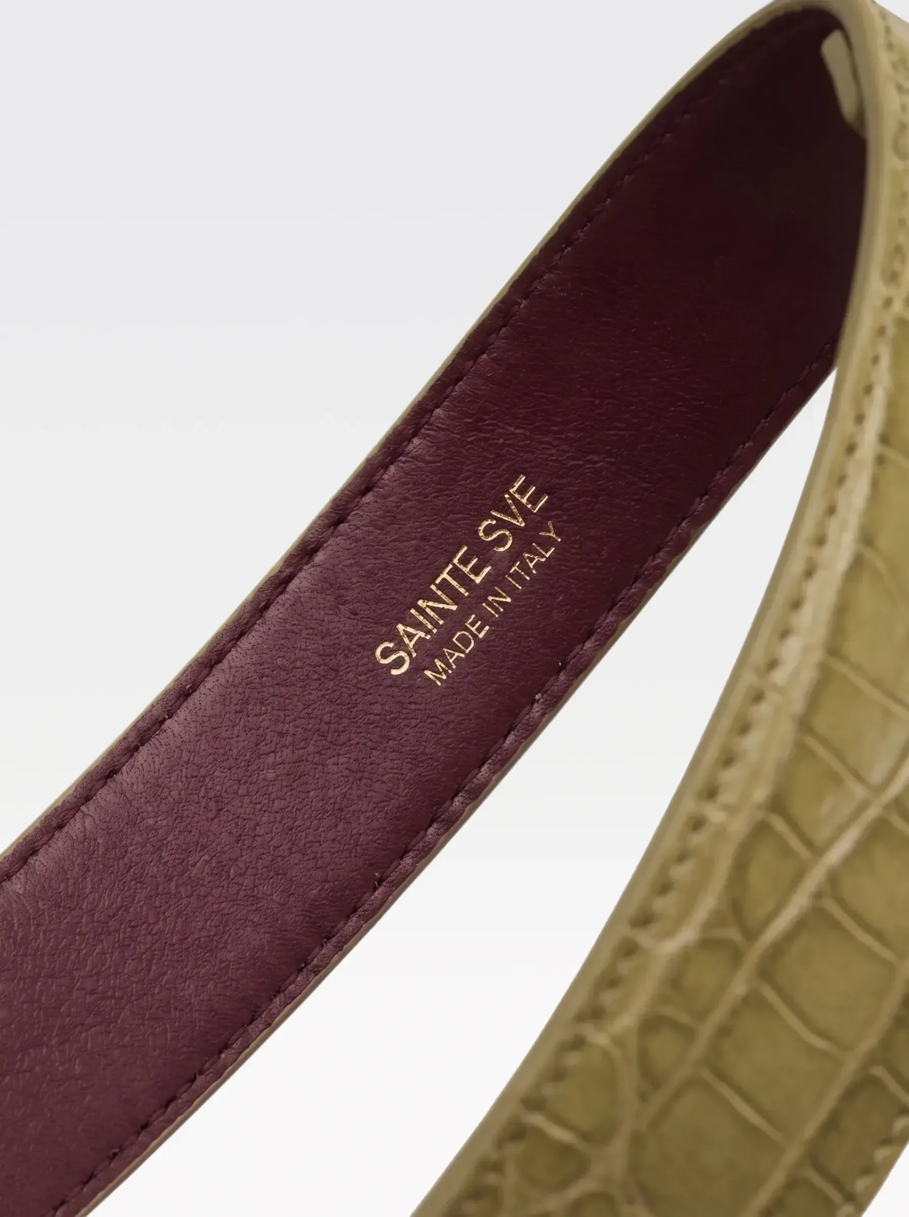 Close-up of the burgundy nappa lambskin lining of the Sainte Sve Garters Croc with the foil-stamped Sainte Sve Made in Italy logo