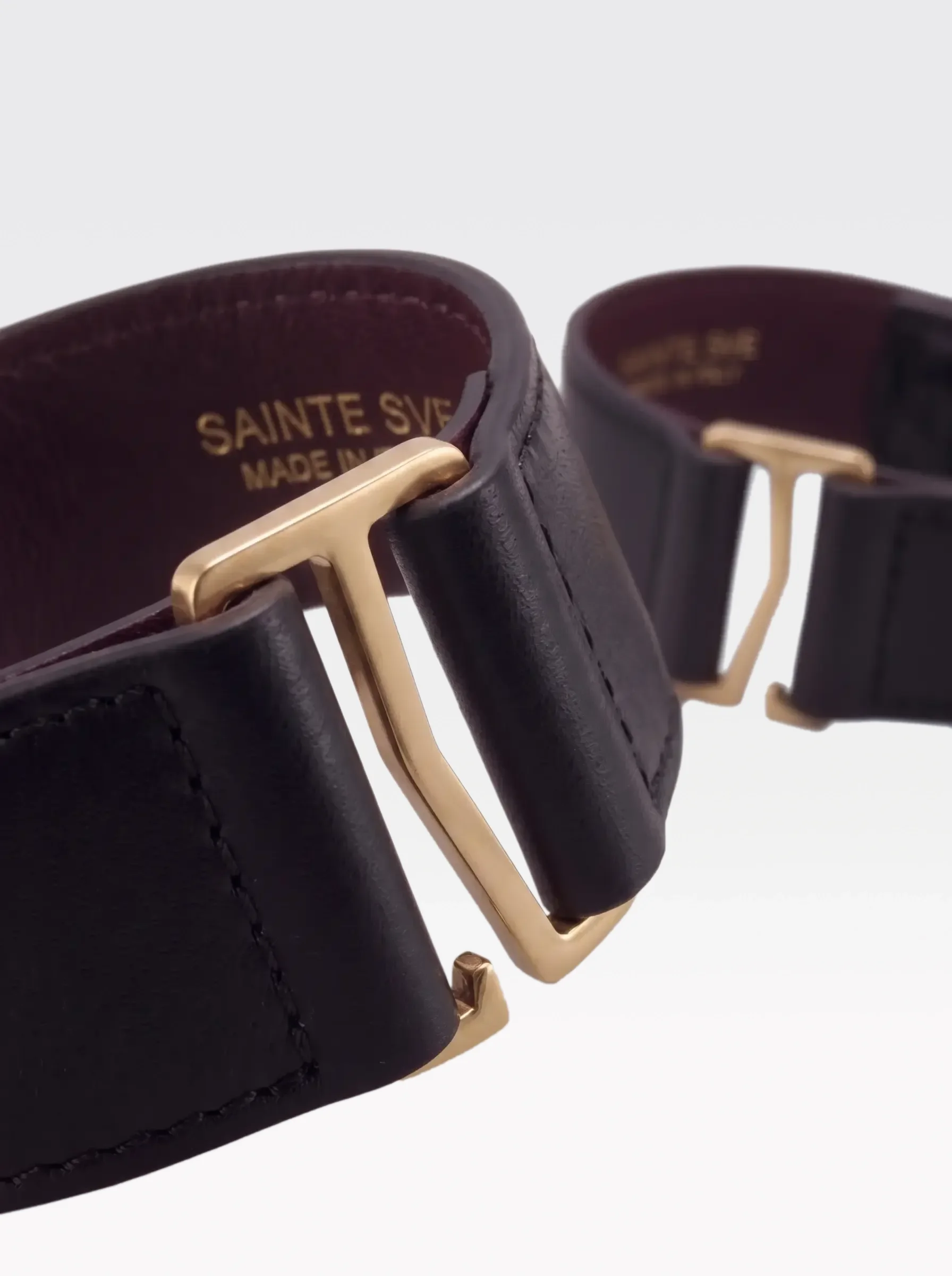 Close-up of the burgundy nappa lambskin lining of the Sainte Sve Ankle Bracelets Nappa with the foil-stamped Sainte Sve Made in Italy logo