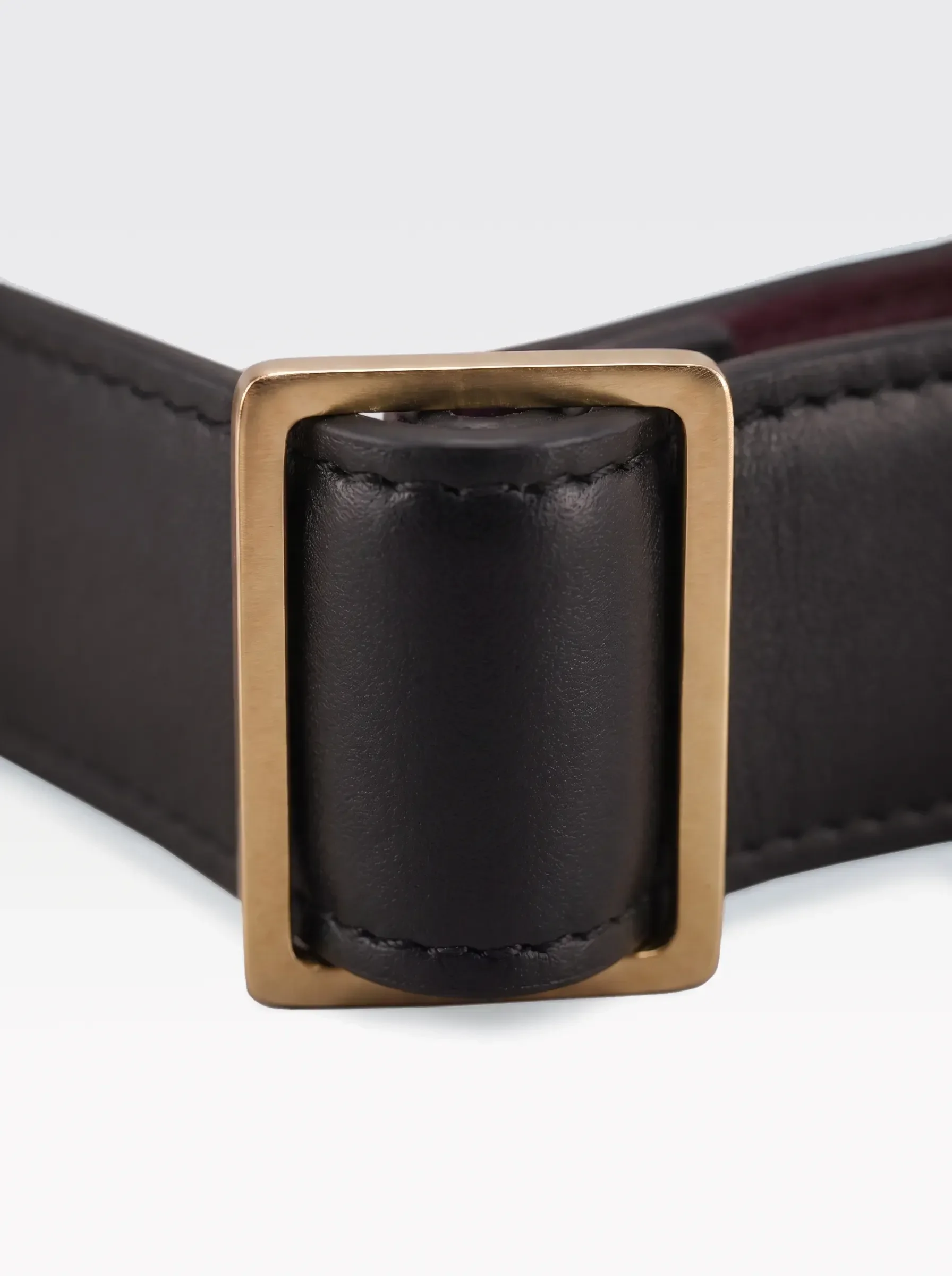 Close-up of the 24K gold-plated brass slider on the black nappa lambskin of a Sainte Sve Choker Nappa