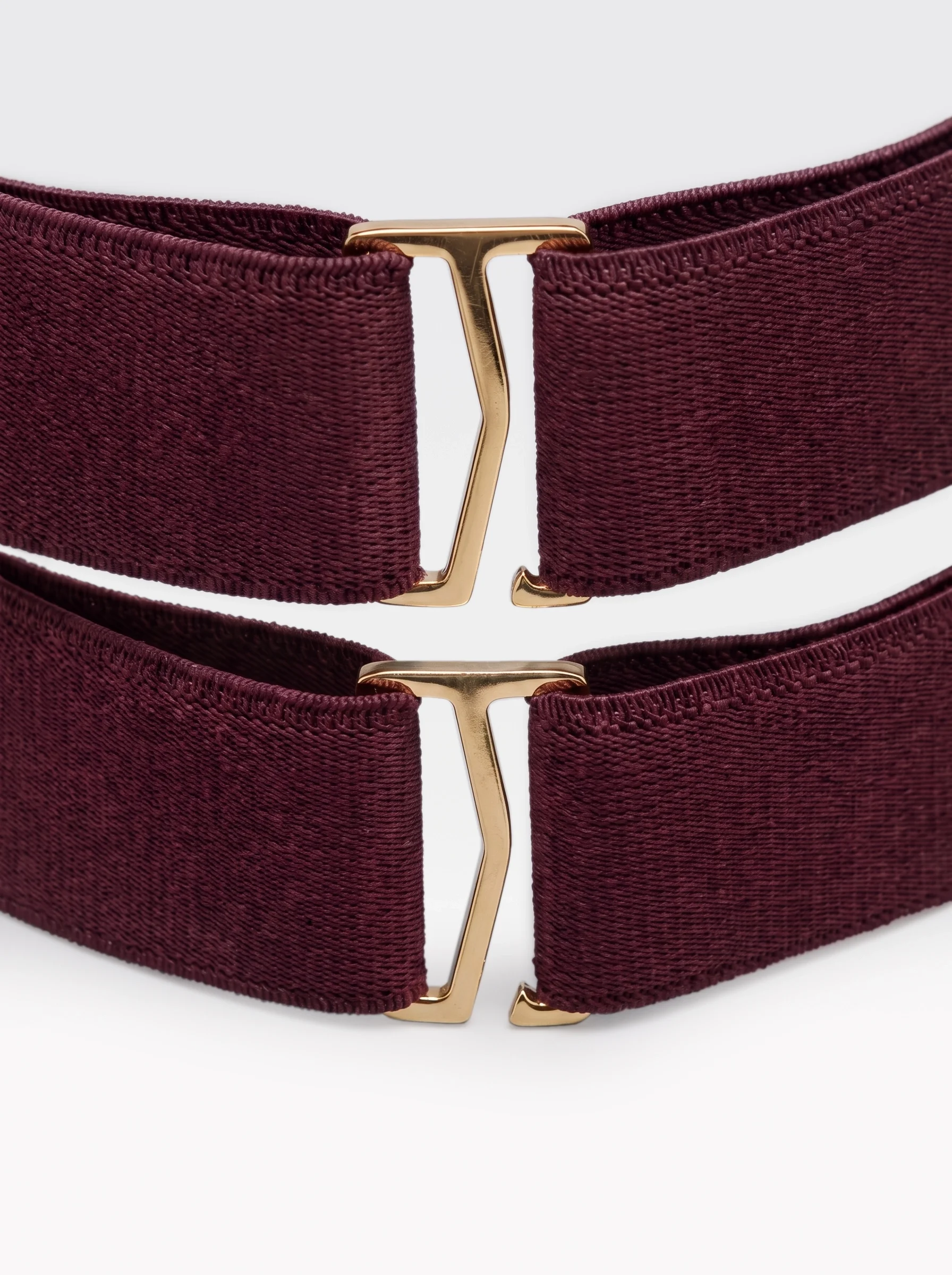 Close-up of the 24K gold-plated brass sliders on the burgundy elastic bands of the Sainte Sve V.N.V Croc