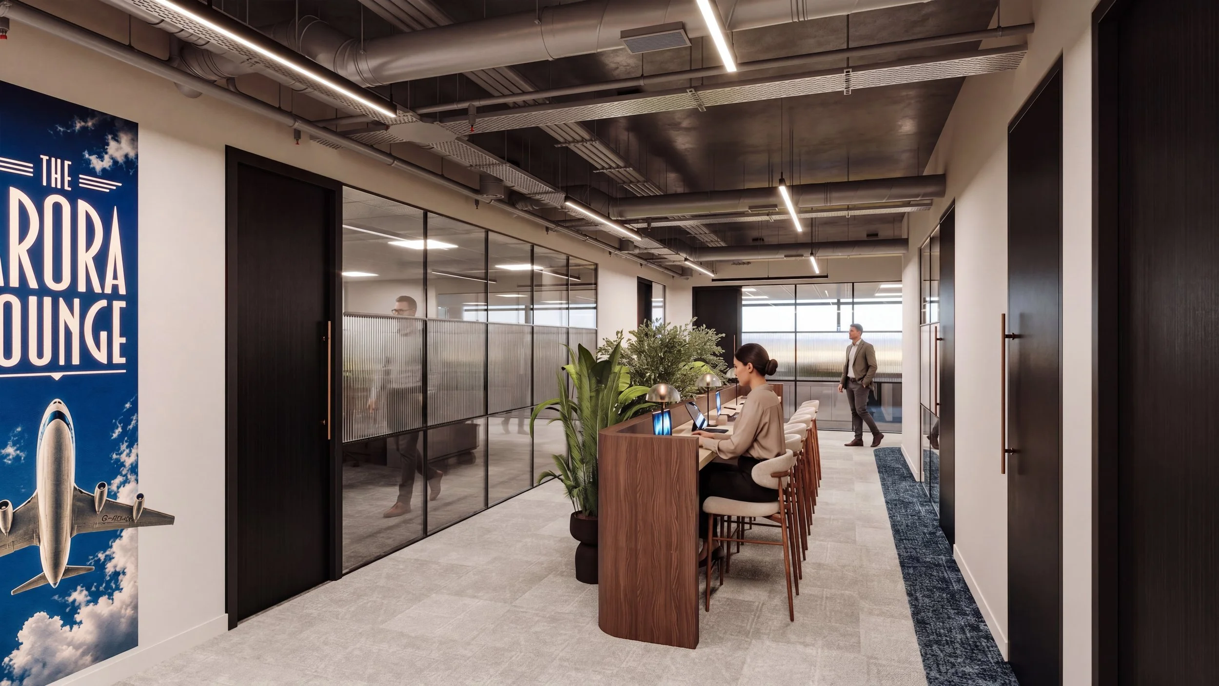 Modern office space with a woman working at a desk with multiple computer monitors, plants, and contemporary lighting, with glass-walled meeting rooms and a man walking in the background.