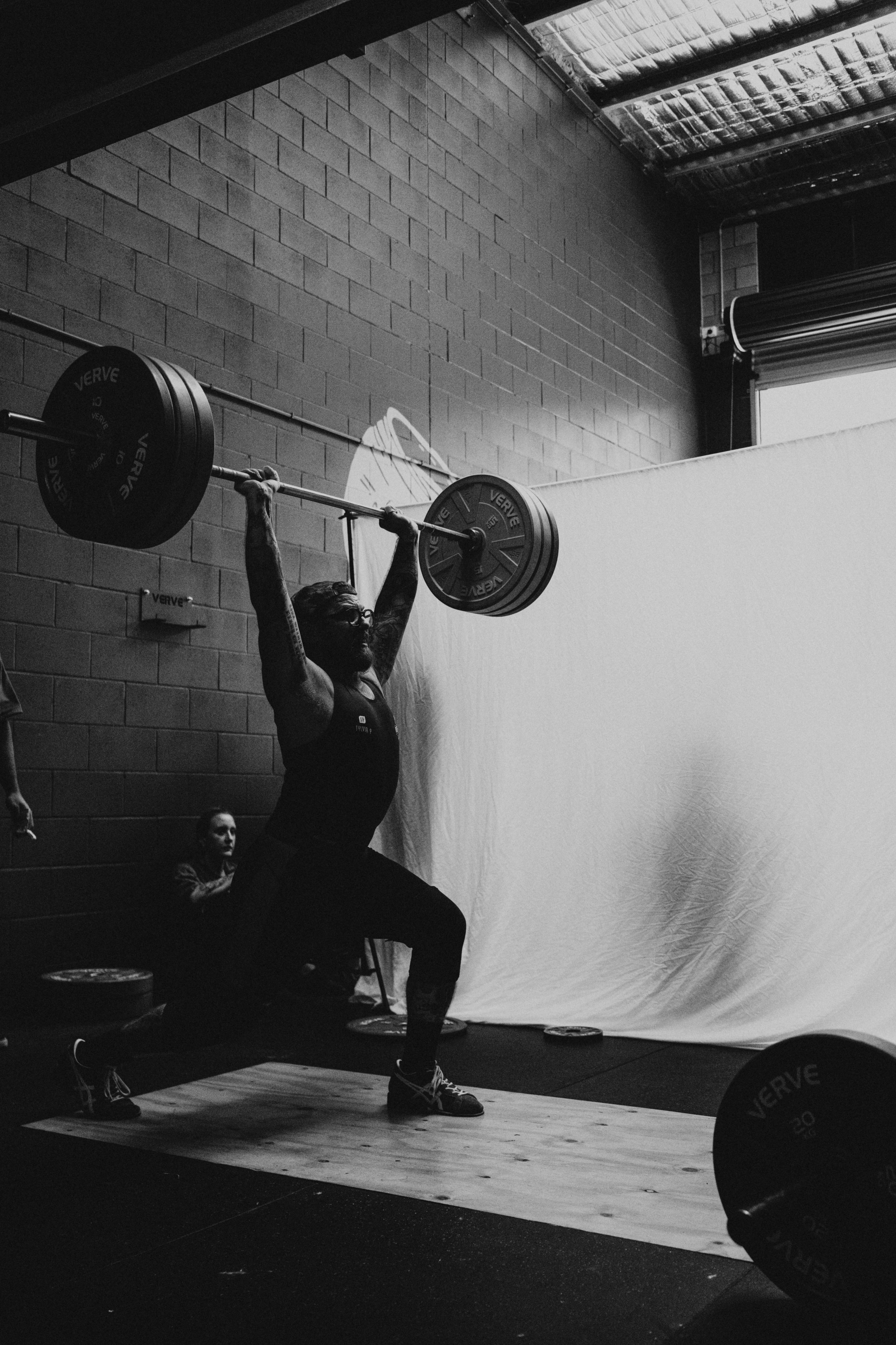 Weightlifter holding a barbell overhead at Crucible