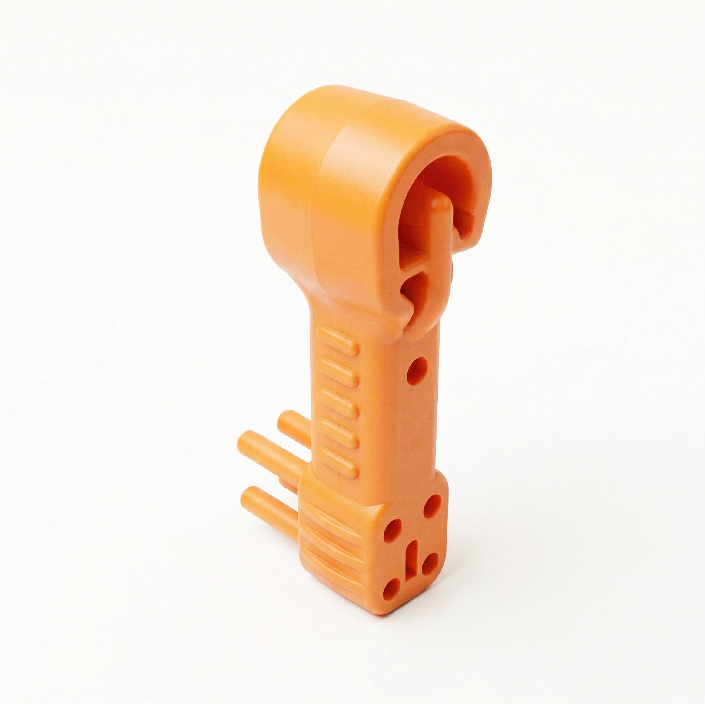 Orange plastic object with holes and slots, isolated on a white background.