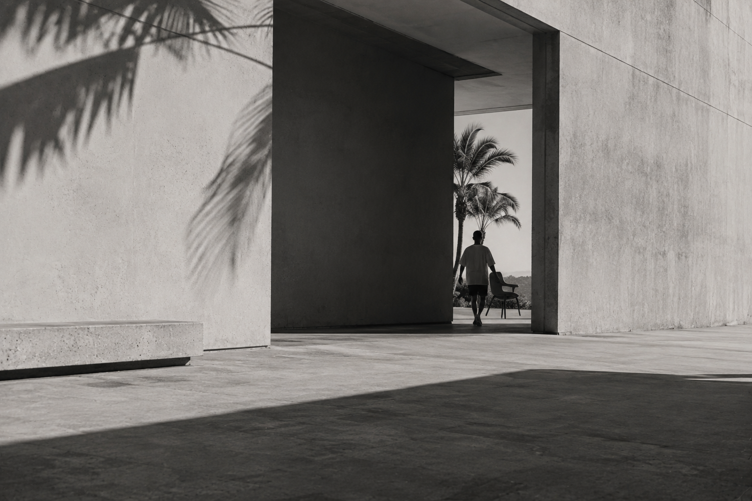 Black-and-white editorial image of a person walking past a chair and palm trees, accompanying The Little Helper’s embedded marketing approach.