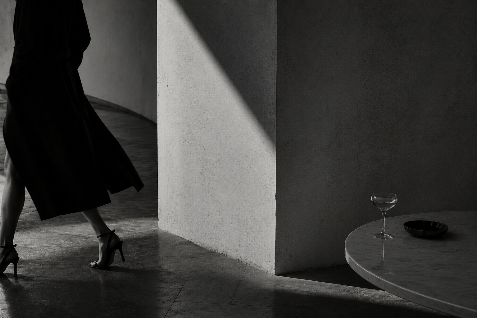Black-and-white editorial image of a woman walking past a café table, accompanying The Little Helper’s integrated marketing introduction for Gold Coast Australia
