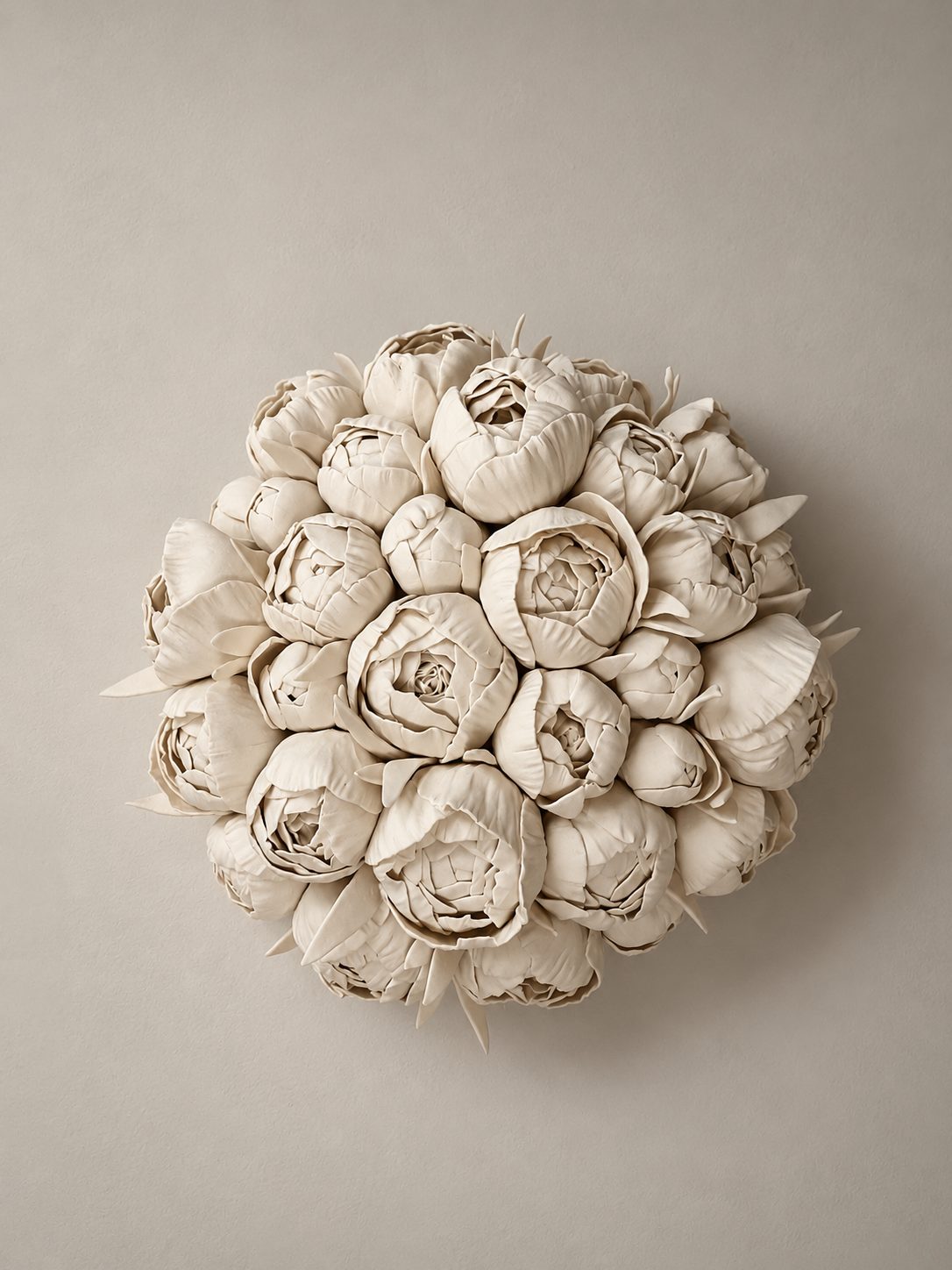 Cream-colored bouquet of artistically crafted peony flowers against a neutral background.