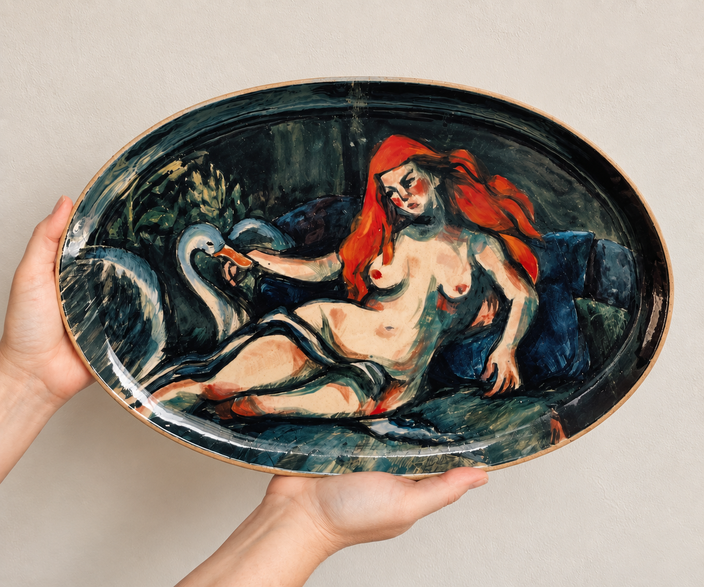 A hand-painted ceramic platter featuring a stylized, abstract depiction of a nude woman with long red hair, reclining with a swan, surrounded by dark foliage.