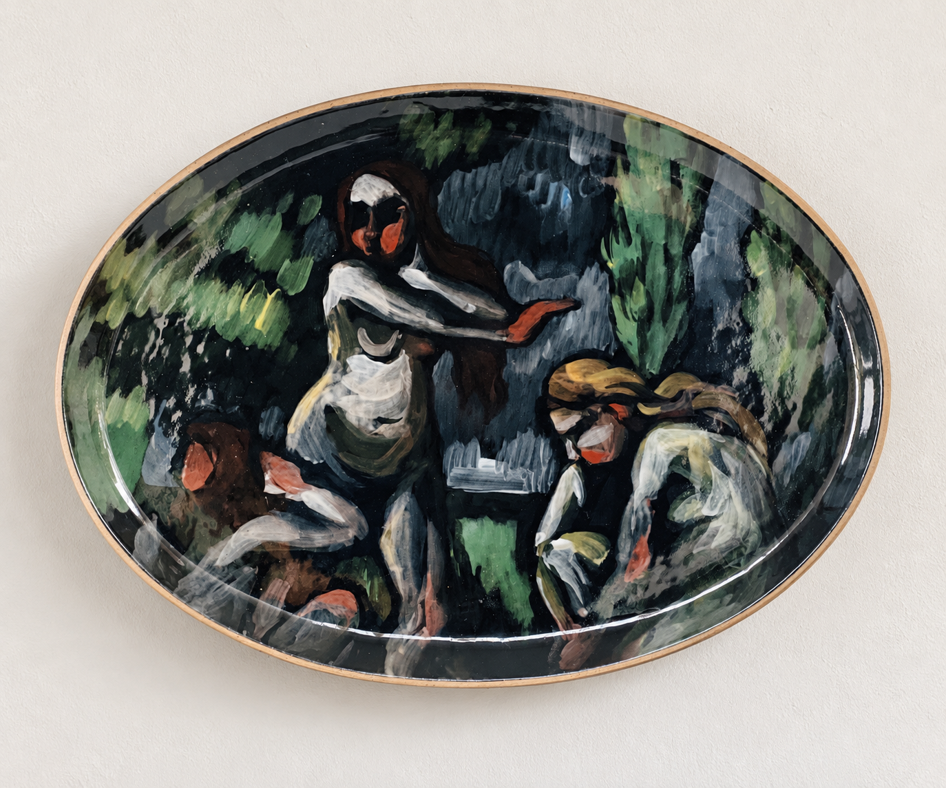 Oval ceramic plate with a painted scene of three women in a lush, green, outdoor setting, with one woman standing and two women sitting on the ground.