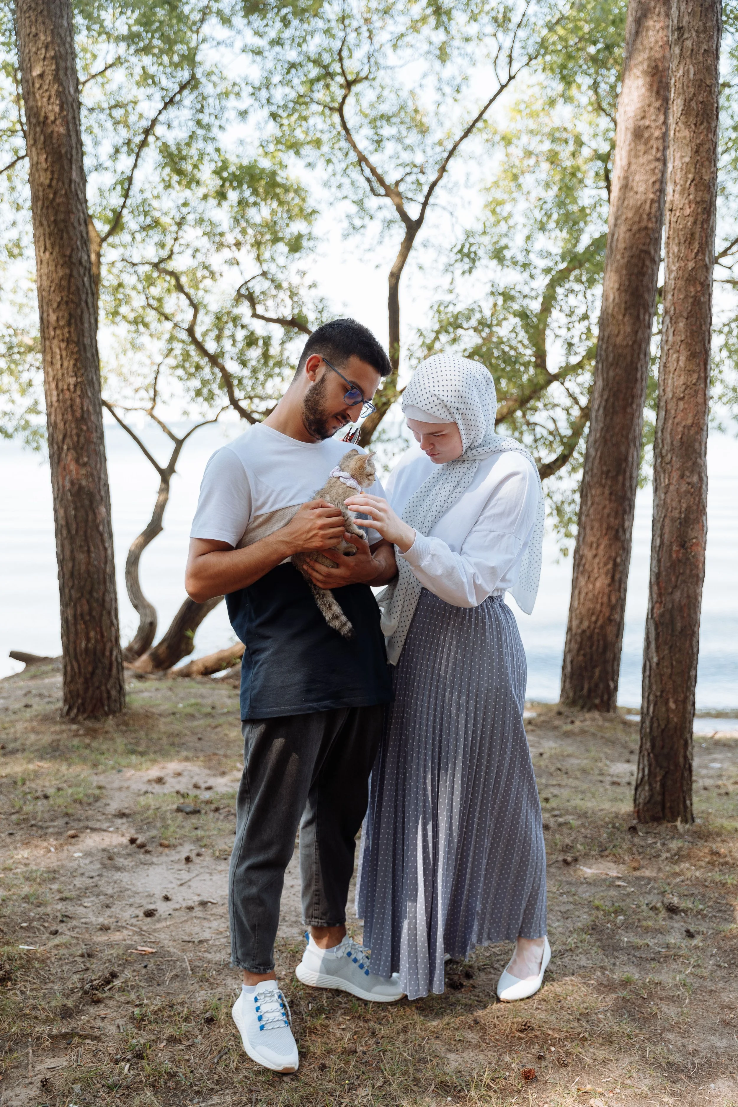 Couple spending time outdoors with a kitten