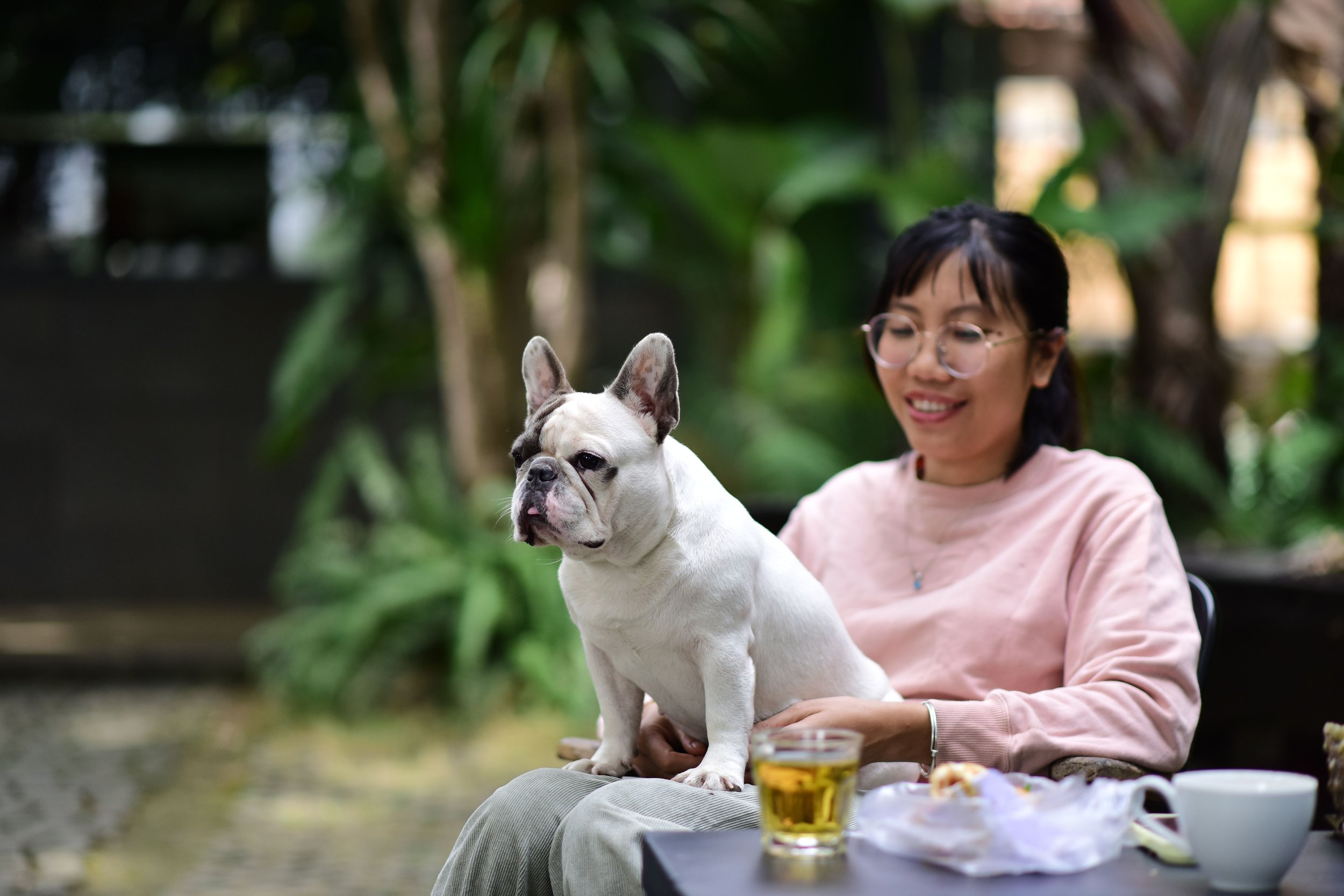 Person sitting outdoors with a dog