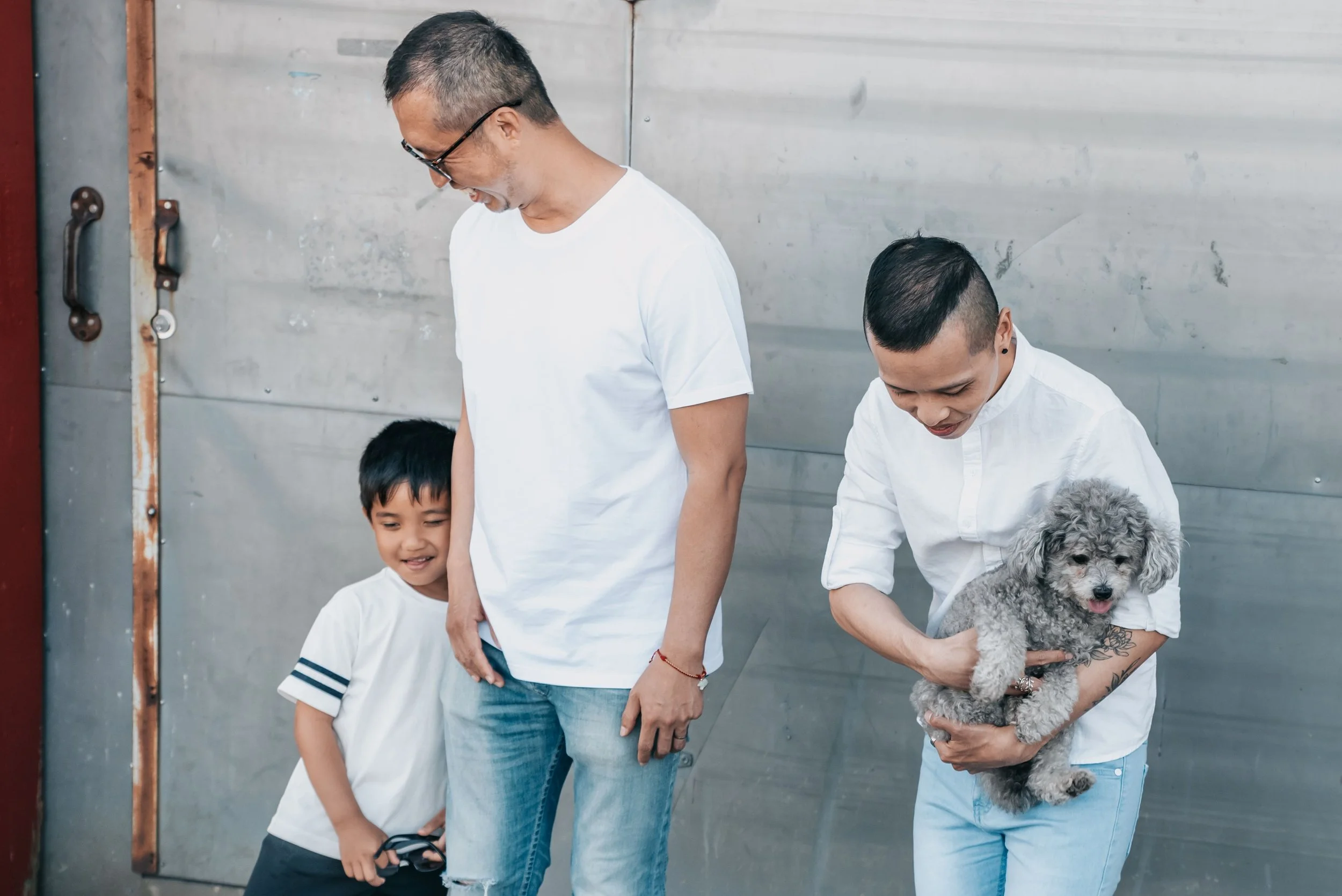 Family spending time with a small dog