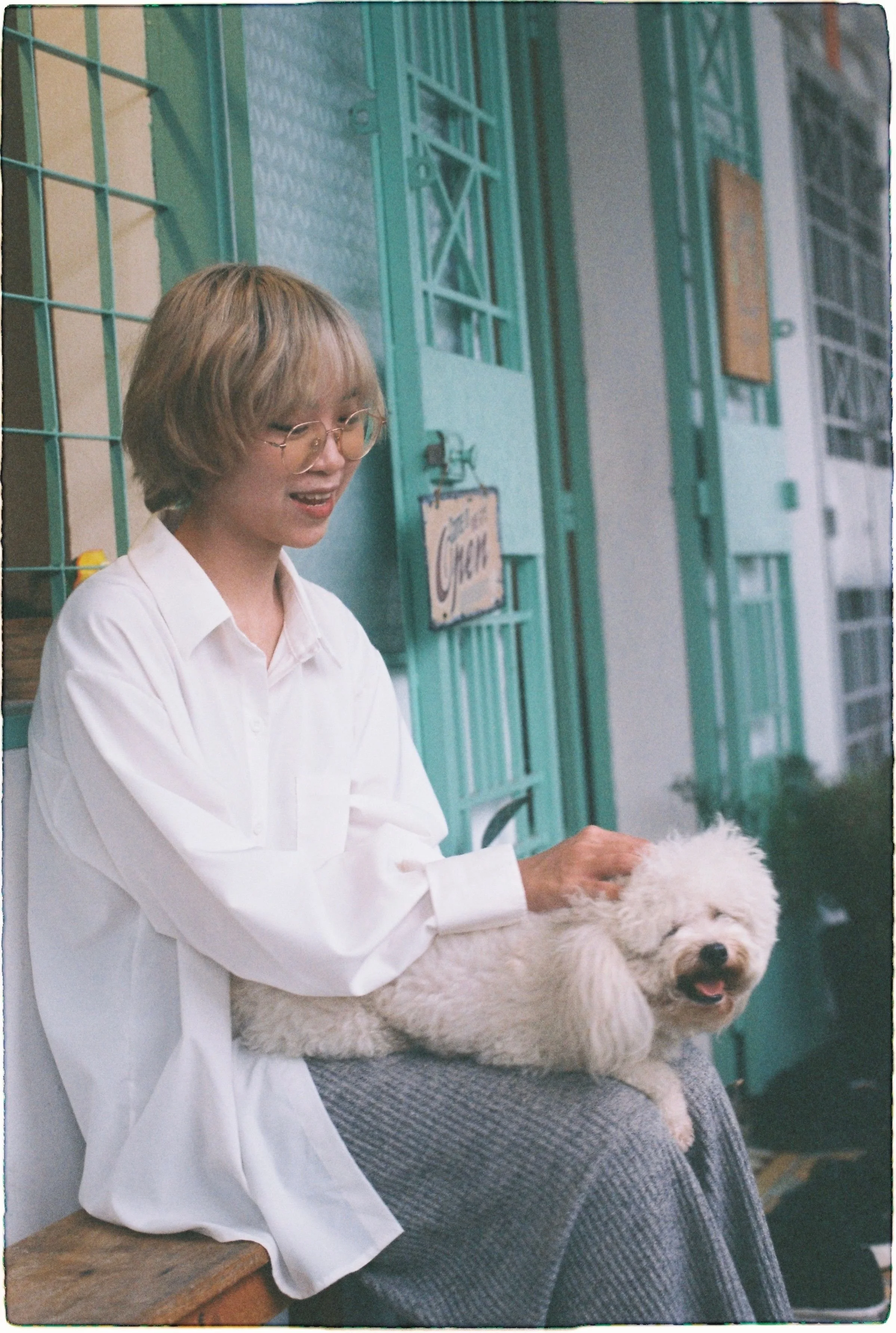 Person spending time with a small white dog