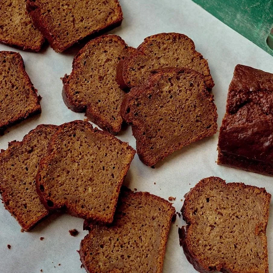 Slices of gingerbread cookies on parchment paper.