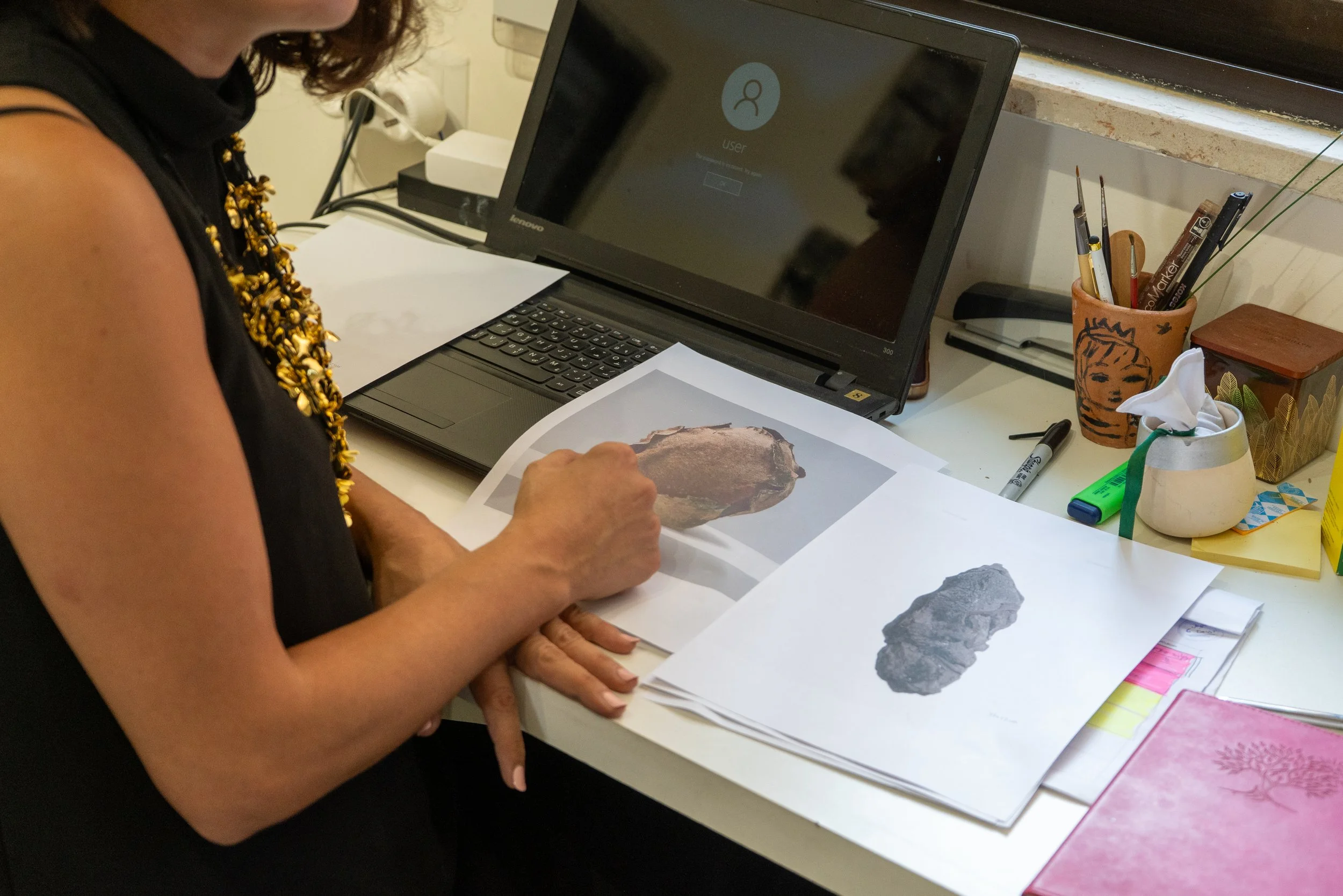   Khuzama Abu Joudeh  reviewing photographs of her ceramic works at her studio. 2 September 2026 © Photo by Yasr Abdalla 