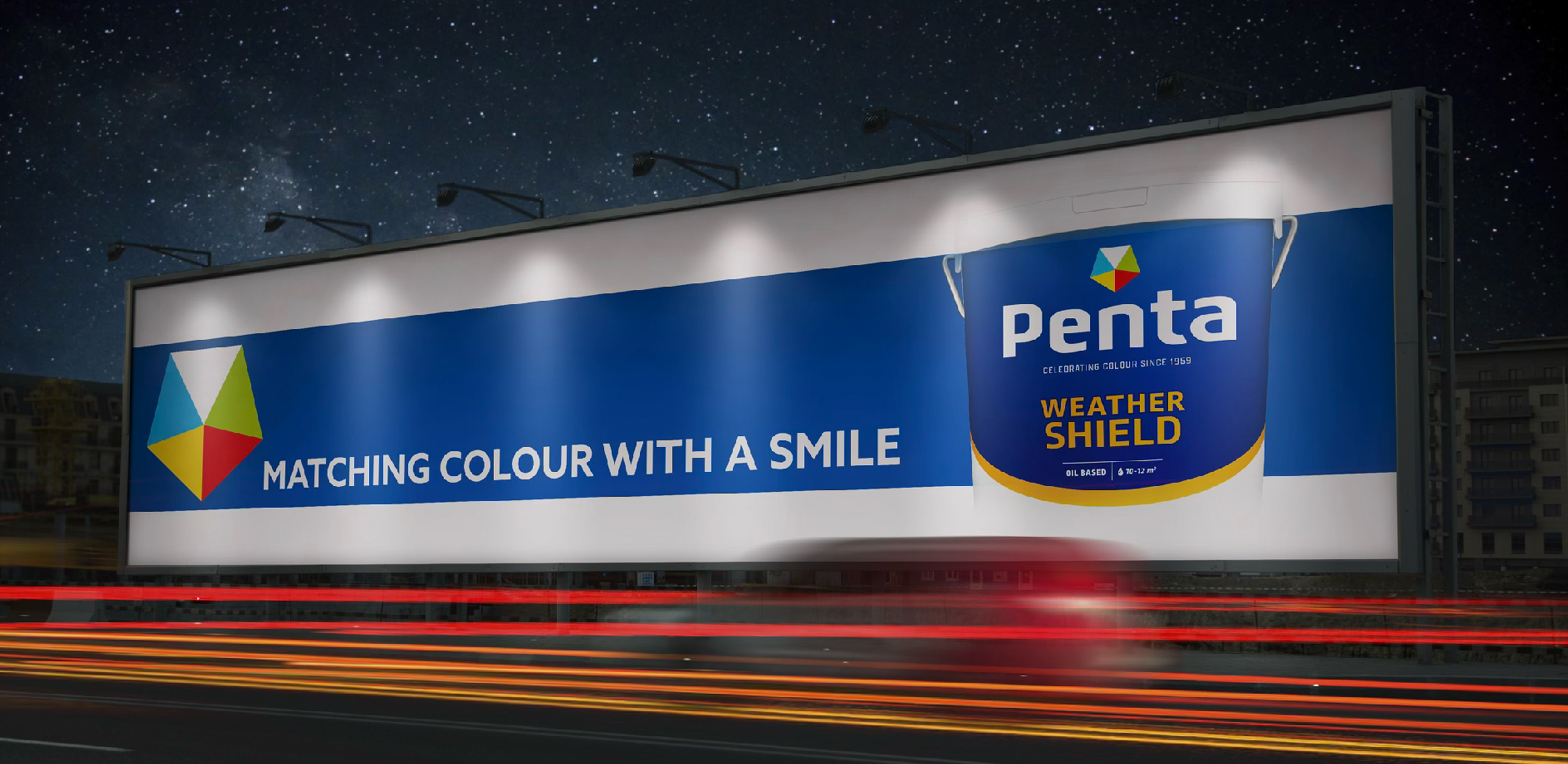 Billboard advertisement for Penta Weather Shield paint with the slogan "Matching colour with a smile" against a night sky filled with stars.