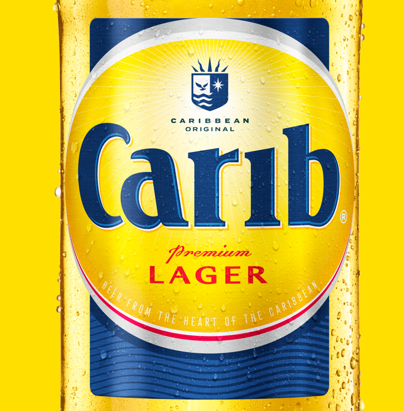 A can of Caribbean Original Carib beer with yellow and blue labeling, featuring droplets of condensation on the surface.