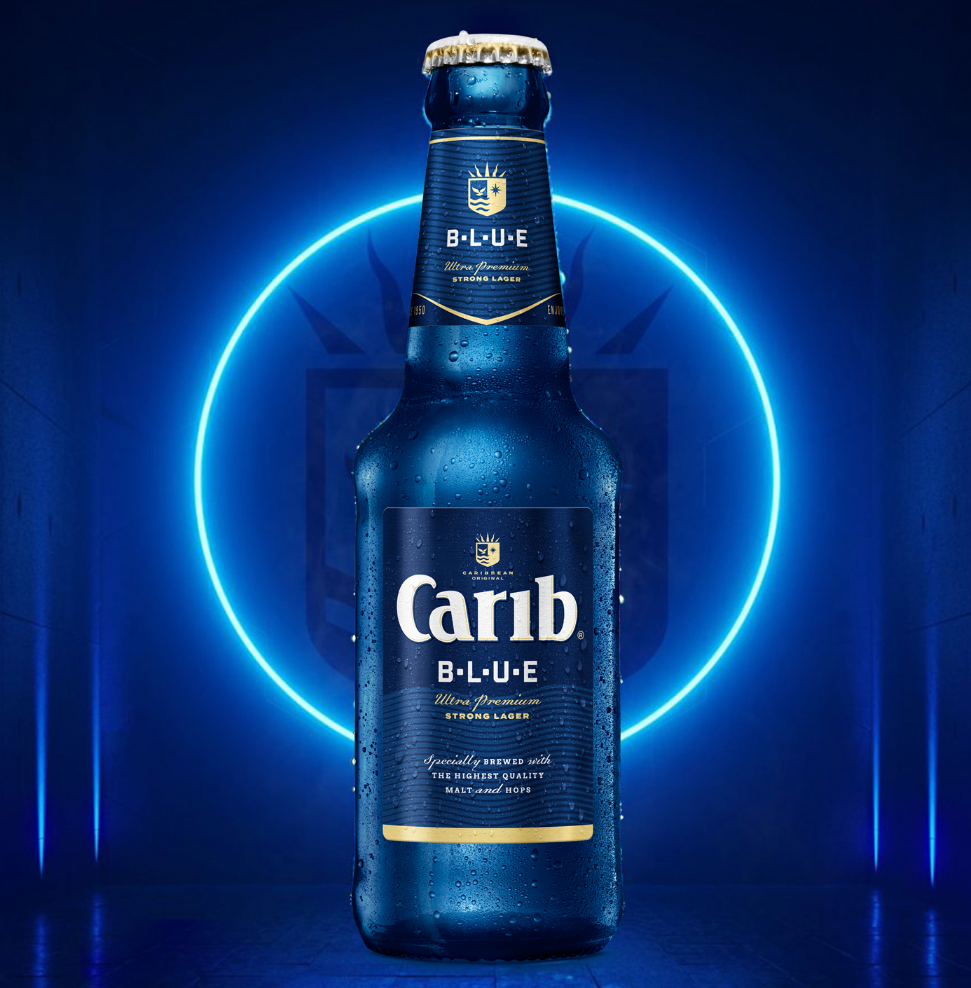 A bottle of Caribbean Blue beer with condensation, illuminated by a blue neon light circle behind it.