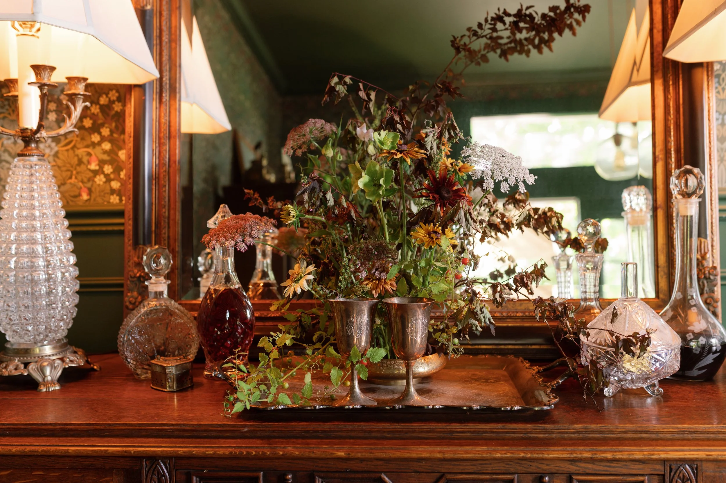 Wedding reception table with layered florals, custom details, and event styling.